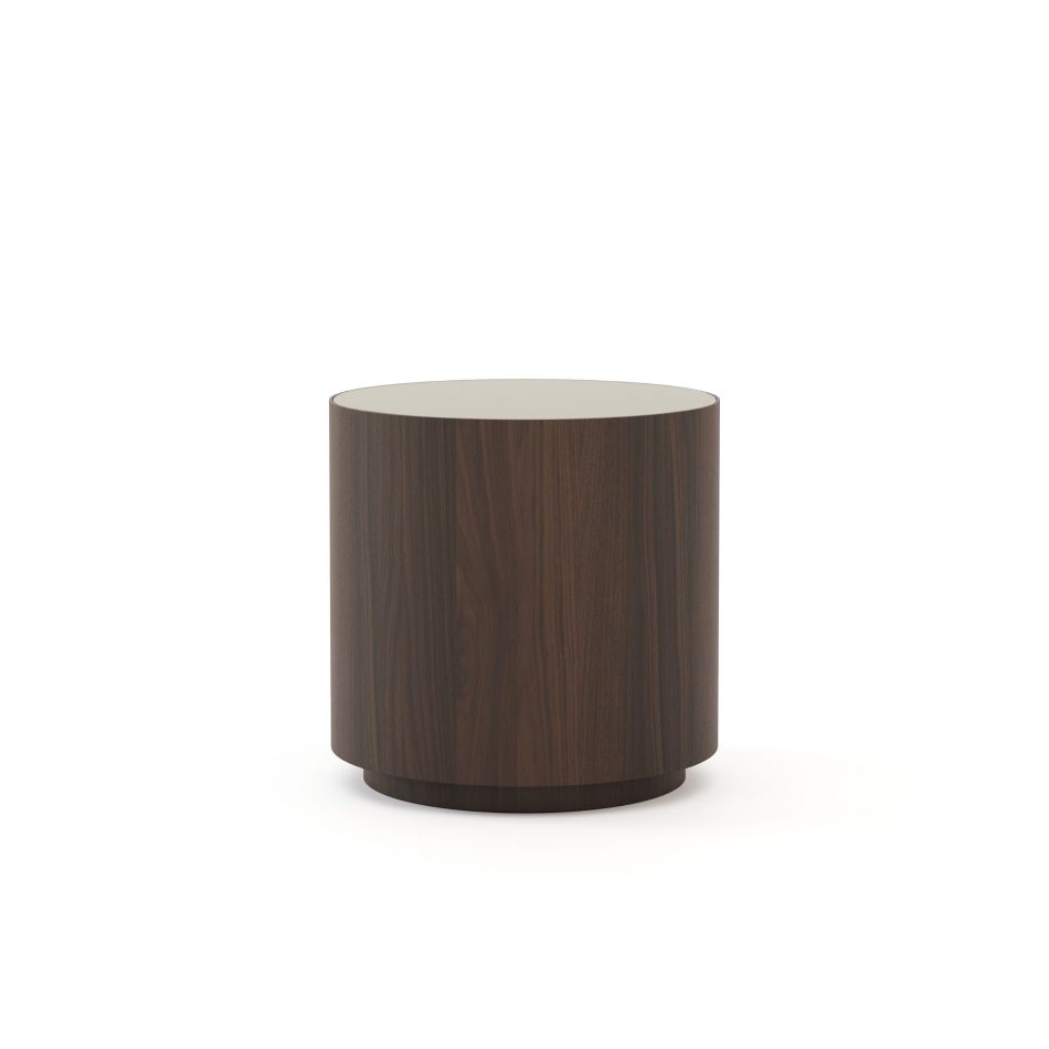 The Drum Side Table appears as a smooth cylindrical form in brown oak wood veneer, topped with glass that adds a luxurious contrast. Its simple round shape and refined textures make it a versatile complement to modern furniture, fitting naturally into living rooms, bedrooms or office spaces with contemporary style.