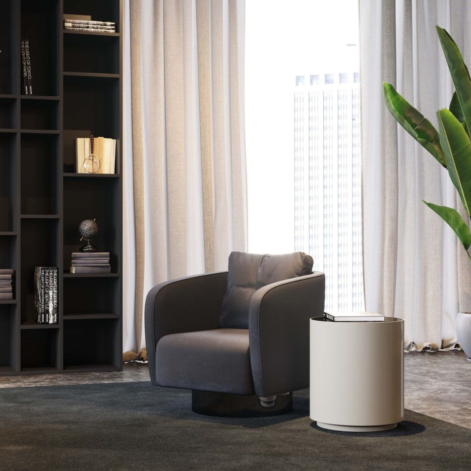 The Drum Side Table stands beside a rounded armchair in a serene reading corner, its brown wood veneer body paired with a smooth marble top. Soft natural light, tall curtains and a mix of modern décor elements create a calm, contemporary ambiance that complements modern luxury furniture, living room furniture and minimalist design details.