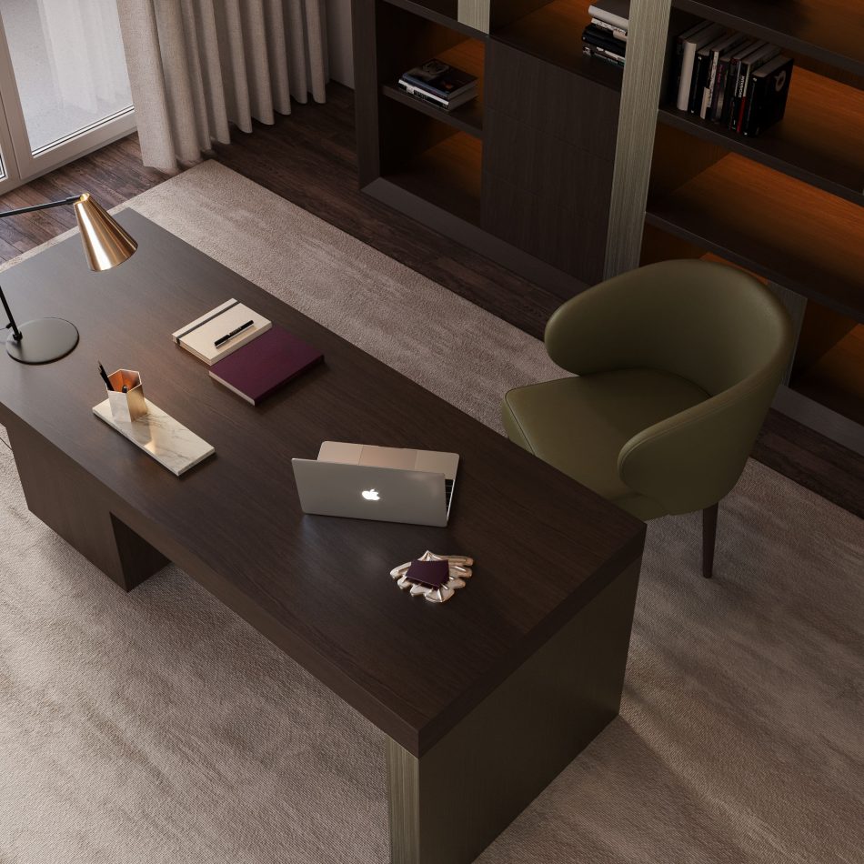The Fortune Chair, upholstered in dark green leather, adds warmth and sophistication to the minimalist desk setup. Its deep back and curved arms enhance comfort, while the dark oak legs introduce a natural, organic note. A gold desk lamp, notebooks and a marble tray complete the serene, well‑styled workspace framed by built‑in shelves and soft natural light. The moment reflects expressive modern furniture design, warm contemporary decor and serene minimalist interiors.