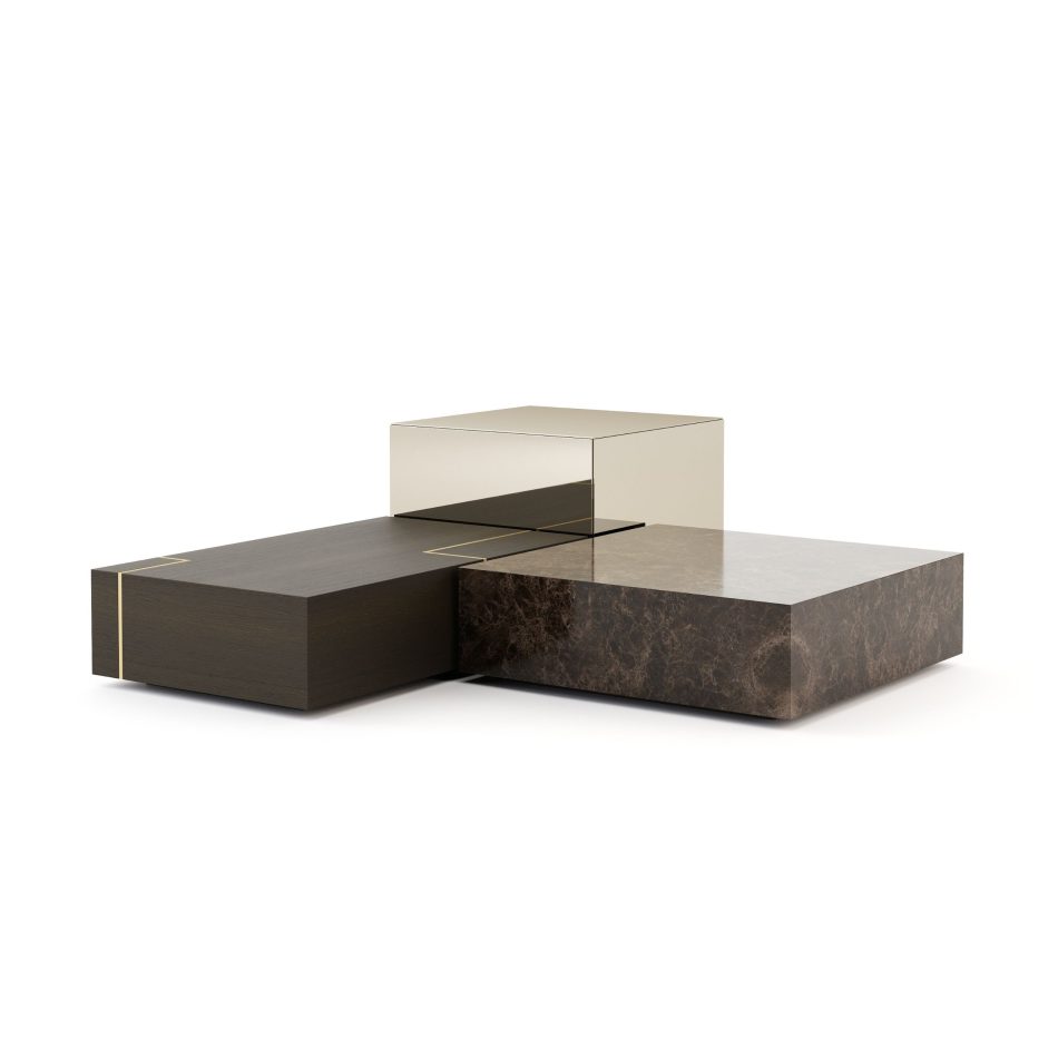 The Fortune Coffee Table set appears as three intersecting blocks in dark wood, polished brown marble, and reflective metal, creating a tiered, sculptural composition. The contrast of noble materials highlights its austere, contemporary character and refined craftsmanship. This statement piece brings architectural luxury furniture into the room, shaped by bold modern furniture lines and elevated through distinctive design details.