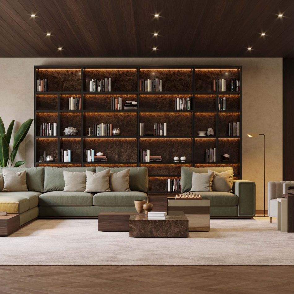 The Fortune Coffee Table set, combining marble, wood, and metallic finishes, sits before a green sectional and a full wall of illuminated shelving. Its tiered geometric blocks add structure to the warm, textural room. The space blends refined luxury home furniture with calm living room inspiration and a touch of sculptural modern table design.