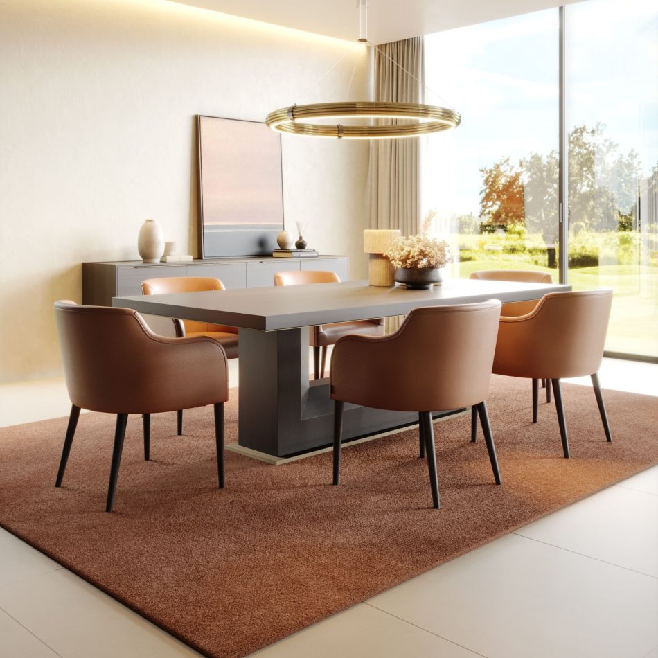 The Fortune Dining Table anchors the room with its dark surface and clean geometry, complemented by brown leather chairs and a minimalist gold‑toned chandelier. A sideboard with sculptural vases and a gradient artwork completes the scene, merging modern dining table design, warm interior design inspiration, and sophisticated luxury furniture.