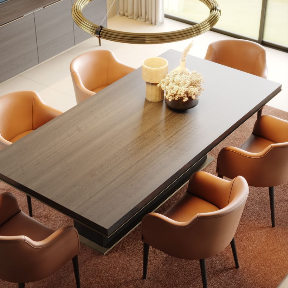 The Fortune Dining Table anchors the dining room with its dark, elegant surface, surrounded by tan leather chairs arranged over a warm rug. A gold circular pendant light softens the atmosphere, blending luxury dining room furniture,design details, and elevated interior design inspiration.