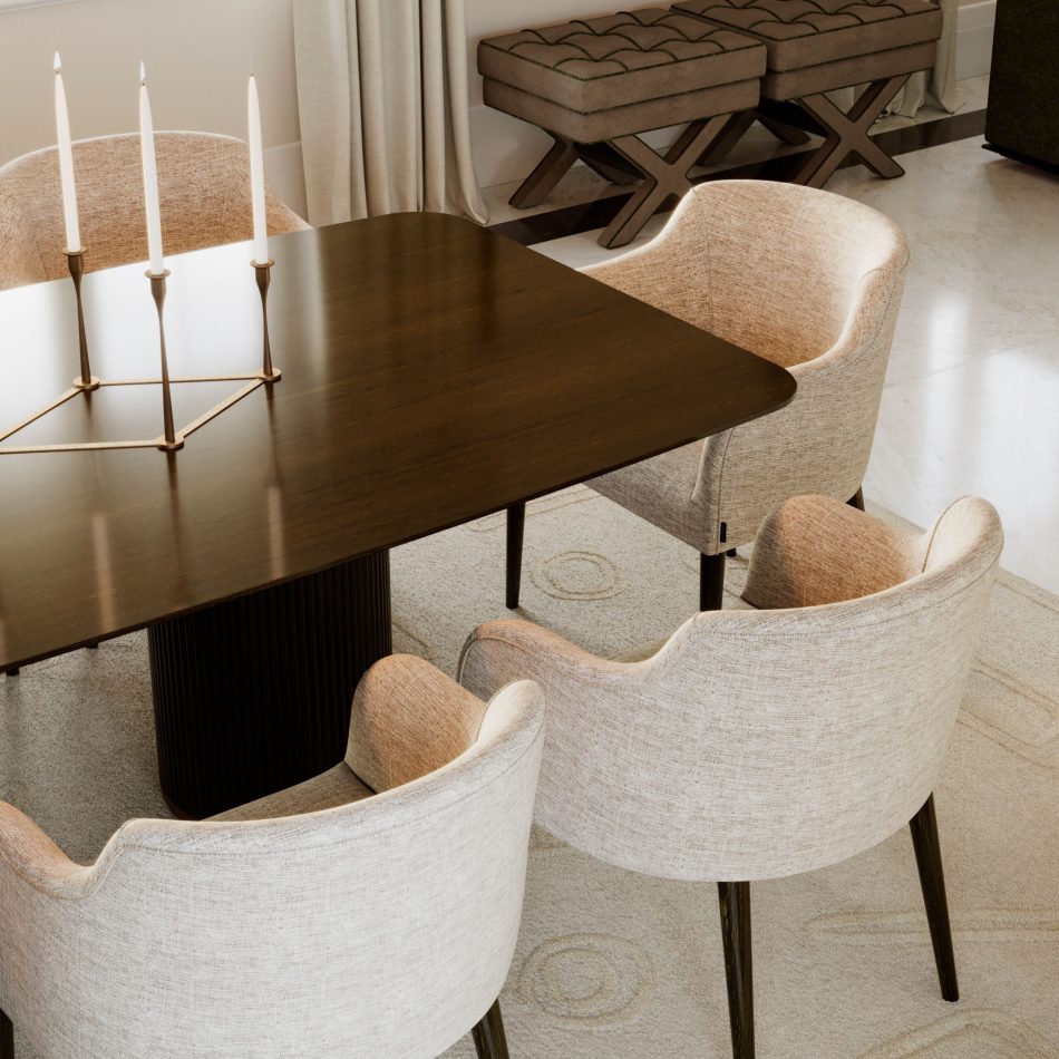 The Her Dining Table features a strong central pedestal base in dark wood with brass accents, contrasting with the delicacy of its smooth top. Paired with curved beige chairs and minimalist candle holders, the room reflects modern furniture, subtle design details, and sophisticated luxury home furniture.