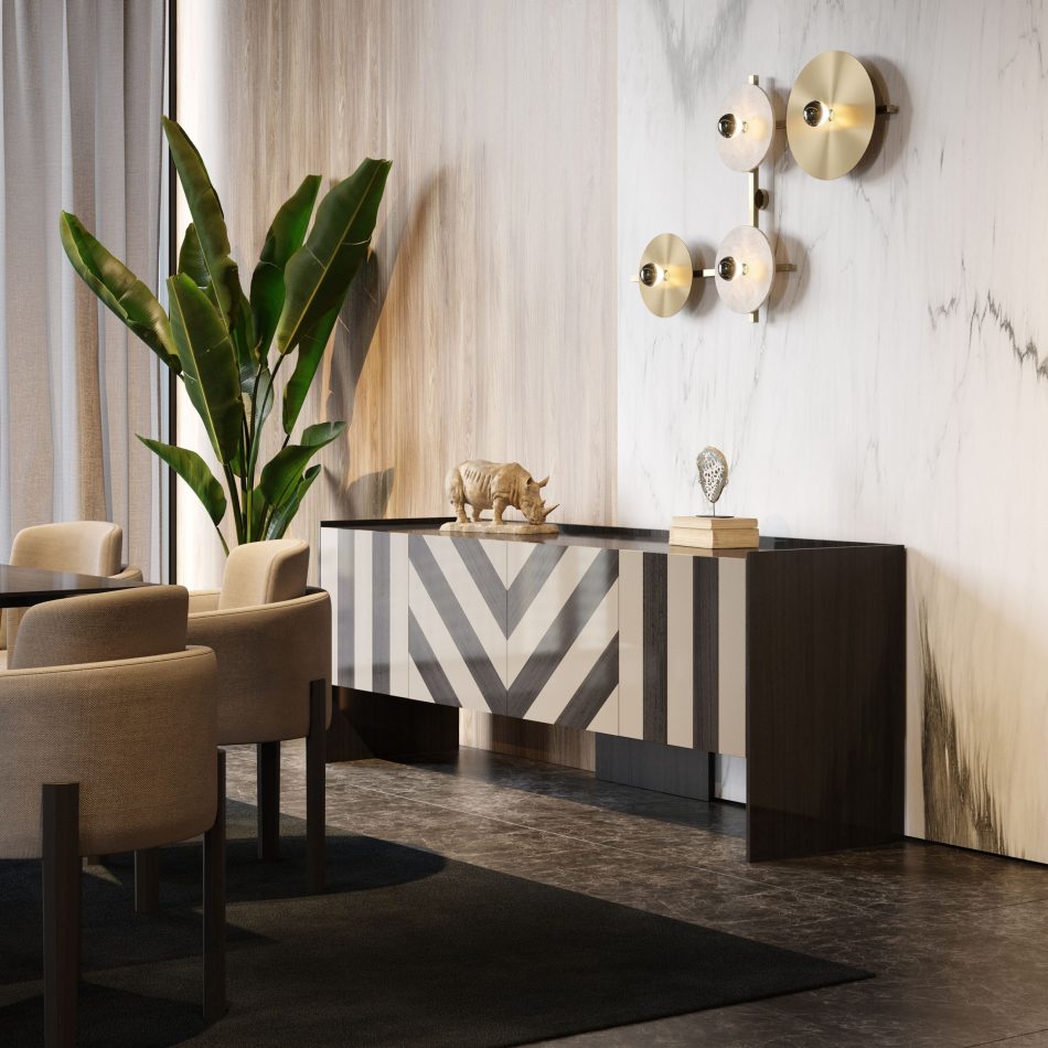 The Her sideboard, with its geometric chevron pattern and contrasting tones, anchors the room beneath brass wall lights and marble textures. Decorative objects highlight its Art Deco influence, creating a focal point within a sophisticated environment of luxury home furniture, expressive design details, curated living room furniture, and bespoke furniture luxury design.