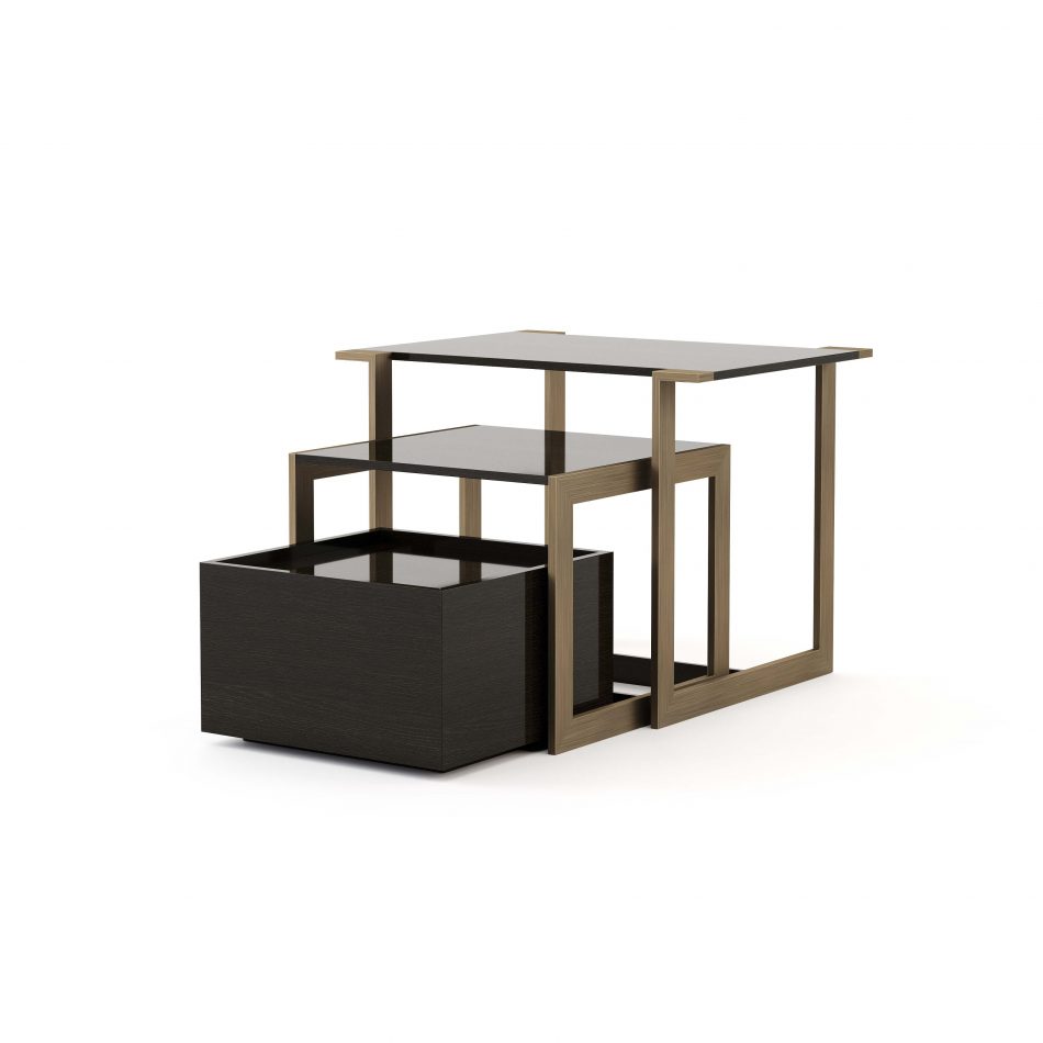 The Fortune Side Table is shown as a modular trio with brushed bronze‑brass frames and high‑gloss dark oak tops, arranged in a clean nested composition. The straight‑line geometry and contrasting materials highlight its contemporary elegance and versatility. The piece brings refined modern furniture into the room, balanced with sculptural design details and the warm presence of luxury home furniture.