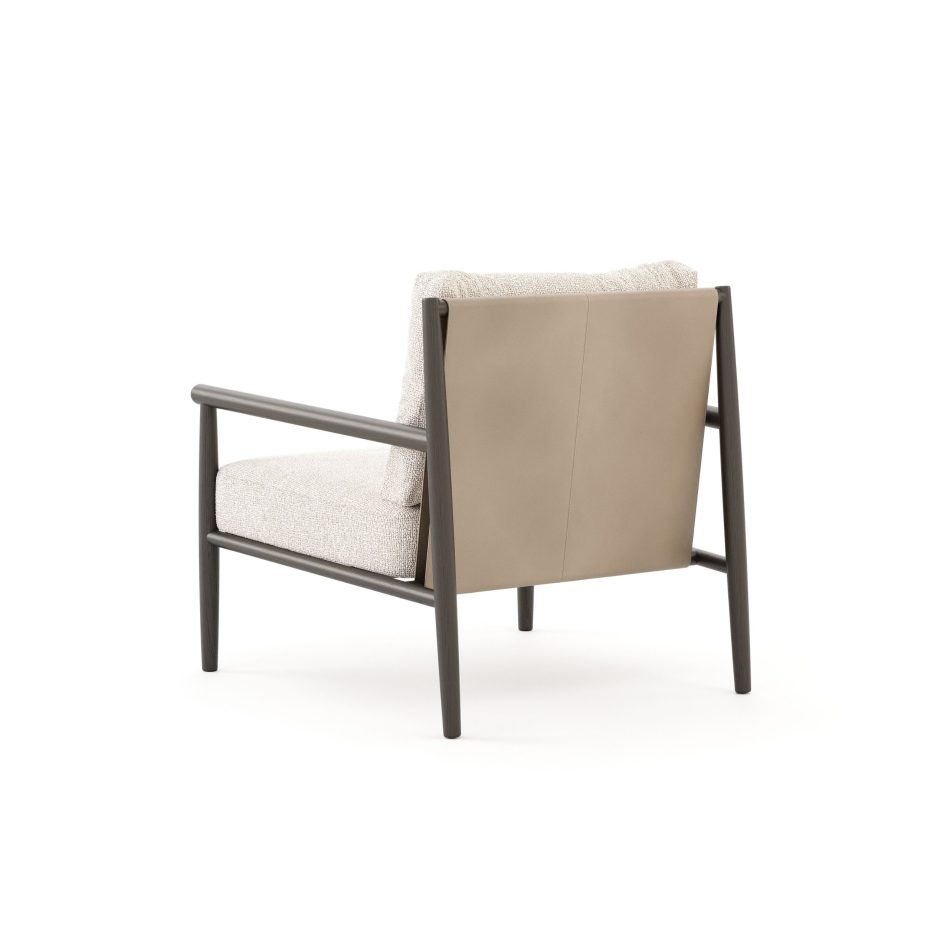 Rear view of the Landform Armchair revealing its leather backrest panel against the bouclé seat cushion, showcasing the leather upholstery detail within this living room furniture design.