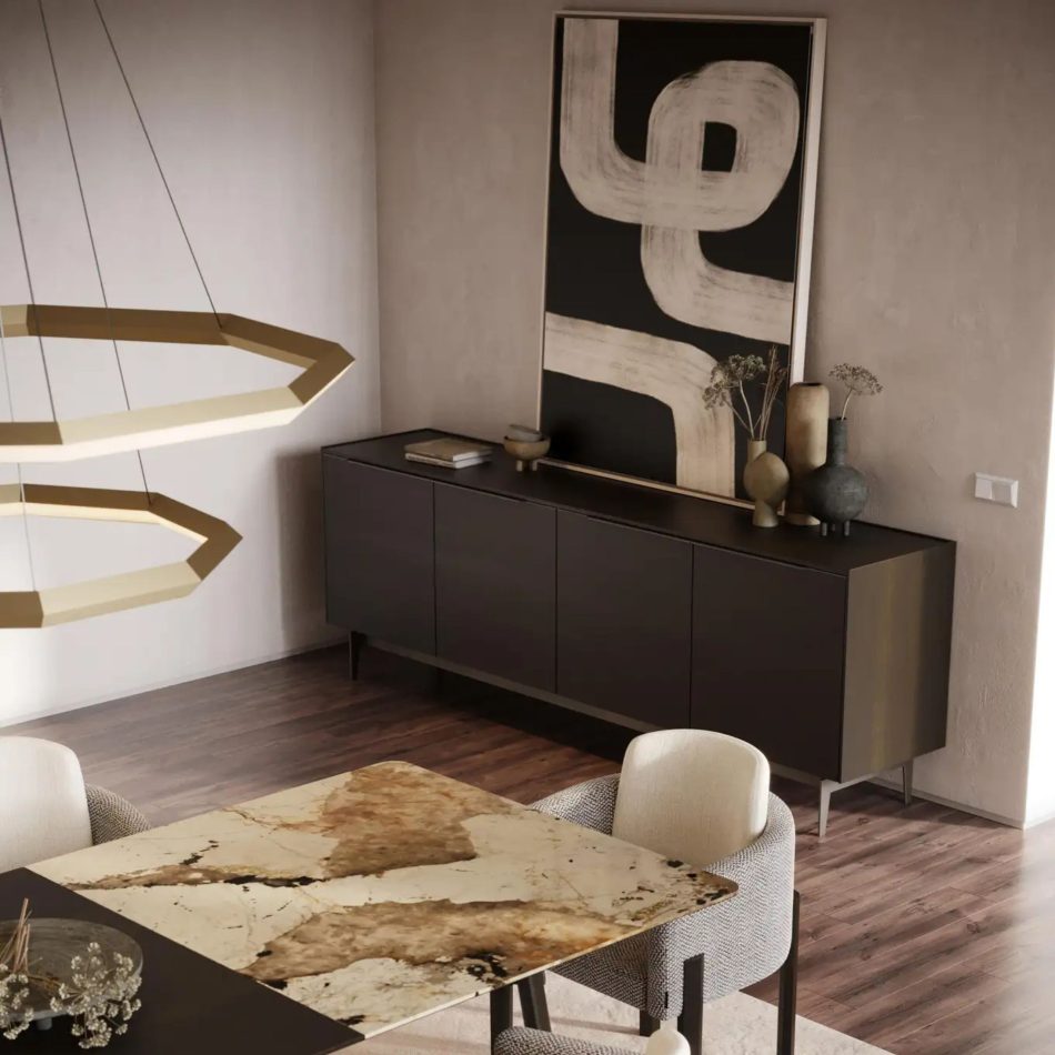 The Landform Sideboard sits behind a polished marble dining table, its dark wood surface styled with neutral vases that echo the tones of the abstract artwork above. Gold geometric pendants illuminate the space, while upholstered dining chairs soften the clean lines of the room. This harmonious composition reflects refined dining room furniture, enriched by the elegance of modern luxury furniture, and arranged to complement a balanced bespoke dining room atmosphere.