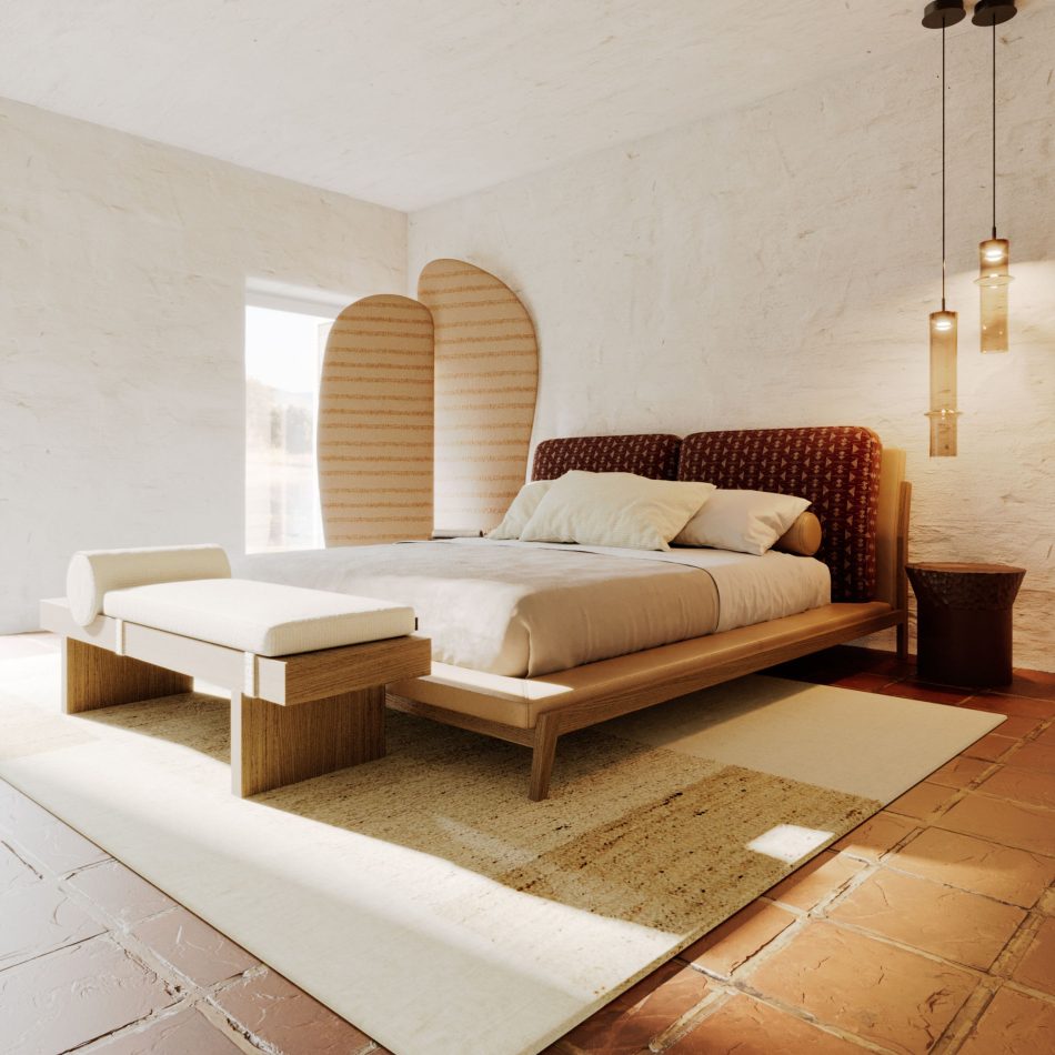 A rustic bedroom where the Milos Bed sits low against a whitewashed wall, its patterned headboard and warm wood frame paired with a matching upholstered bench at the foot. Terracotta floor tiles, arched textile panels, and hanging pendant lights bring texture to the space, while the bed's simple silhouette and considered material combination highlight the kind of luxury bedroom furniture that adapts easily across different decorative environments.