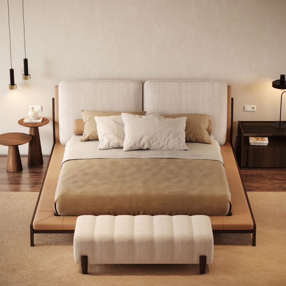 A calm, contemporary bedroom centred on the Milos Bed, its two-panel headboard and tan leather-edged frame paired with a ribbed bench, dark walnut nightstands, and a pair of round side tables. Warm pendant lighting and layered rugs complete the space, showing how the bed's clean, split-panel design anchors luxury bedroom furniture styling with quiet, minimalist detail.