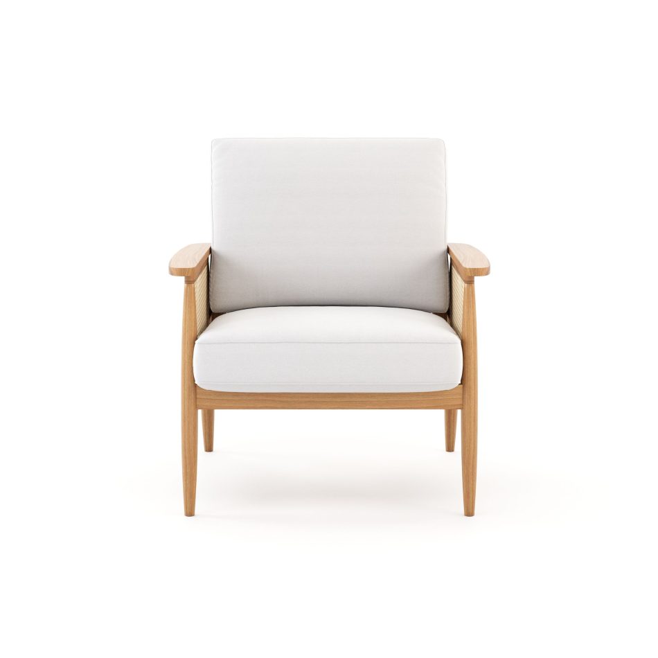 A Natur Armchair featuring a smooth wooden frame with tapered legs, woven cane detailing on the sides, and light fabric cushions. The combination of texture and clean geometry reflects the harmony of natural materials, the refined balance of contemporary furniture, and the calm, intentional aesthetic central to elemental‑inspired interior design.