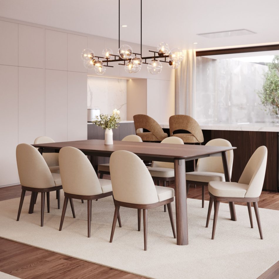 The Natur Chairs frame the wooden dining table with their neutral upholstery and warm wood structure, bringing a sense of comfort to the minimalist dining room. A sculptural chandelier, marble‑backed kitchen, and natural light enhance the chairs’ Nordic character, blending dining room furniture, refined design details, and the harmony of luxury home furniture.