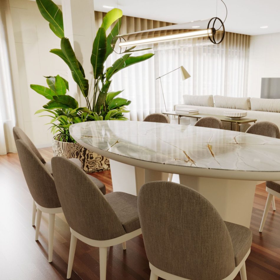 The Natur Chairs surround an oval marble dining table, their upholstery and white legs adding a gentle Nordic contrast to the stone‑veined surface. The neutral fabric enhances the room’s calm palette, connecting the dining area to the adjoining living space with its sofa, floor lamp, and greenery. The scene blends luxury home furniture, crafted modern furniture, and warm interior design inspiration.