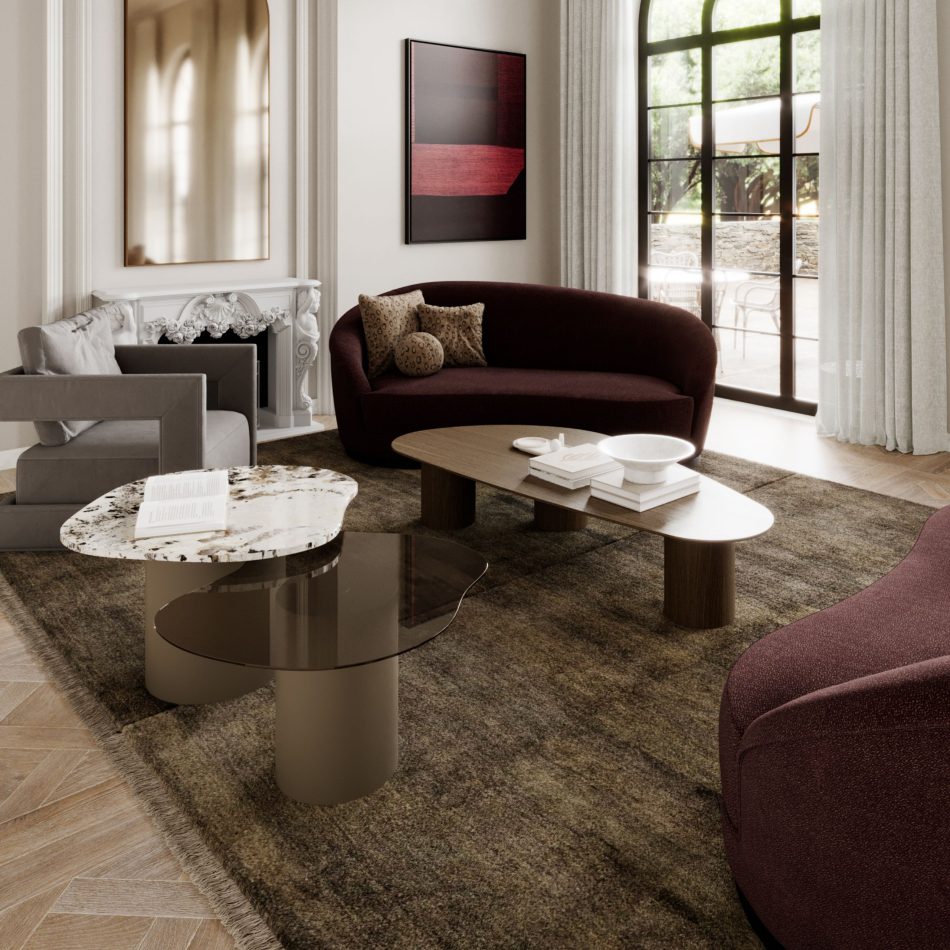 The Natur Side Tables appear as a sculptural trio with rounded tops in marble, tinted glass, and wood, arranged beside a curved sofa under soft natural light. Their nature‑inspired silhouettes enhance the space with living room furniture, warm wood texture, and serene living room inspiration.