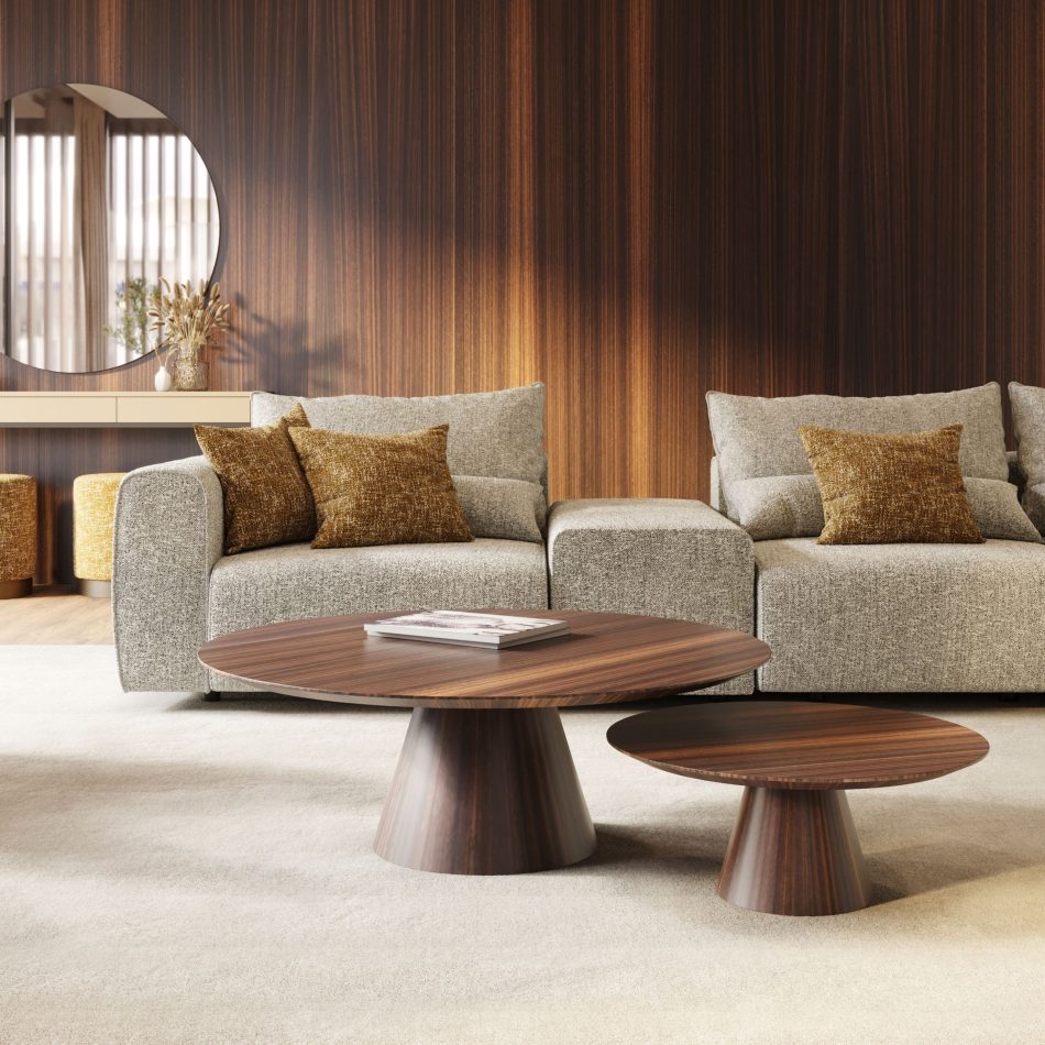 Warm, moody living room ambiance with dark wood paneling, featuring a nesting dark wood Olivier luxury coffee table set centered on a plush rug before a beige modular sofa, highlighting refined minimalist design.