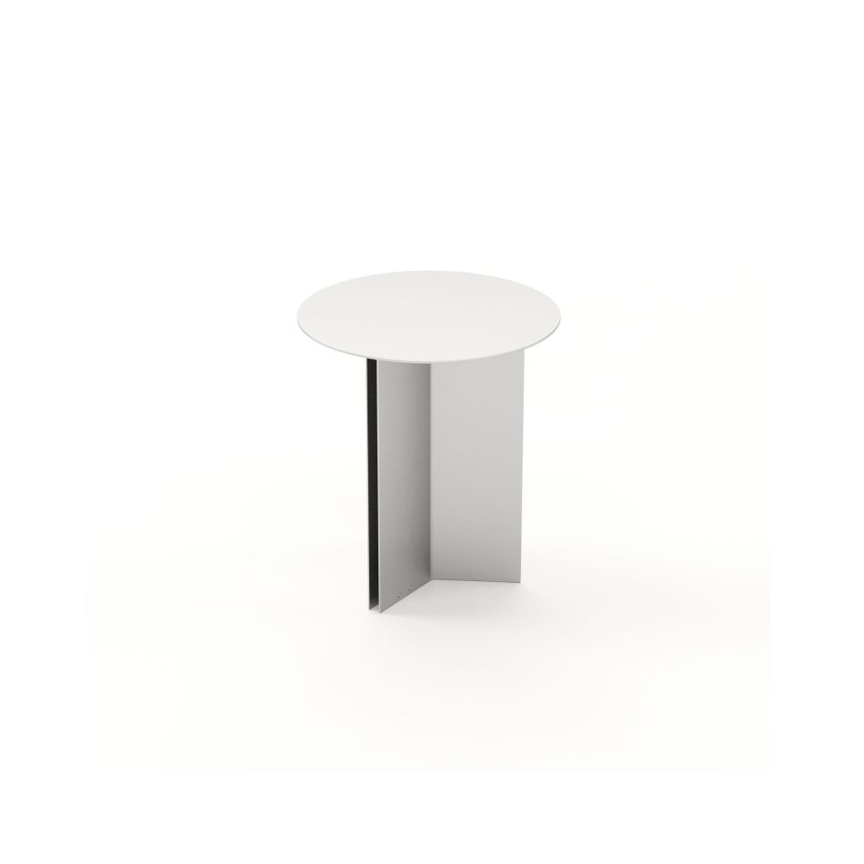 The Steel Side Table in stainless steel brushed appears with its circular top and cross‑shaped base, emphasizing the purity of its geometry. The smooth surface reflects light softly, giving the table a calm, contemplative character suited for intimate corners or reading spaces. Its simplicity aligns with the refinement of contemporary furniture, the quiet warmth of home furniture, and the crafted intention behind subtle design details.