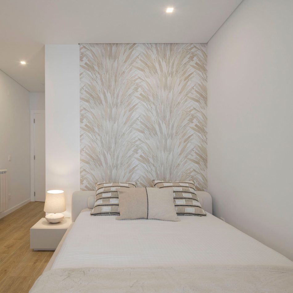 A calm bedroom where the Bespoke Porto Bed introduces quiet structure through its soft lines and neutral tones. Beside it, the Santorini Night Table adds subtle function without disturbing the room’s simplicity. Gentle light and restrained blue accents contribute to an atmosphere of luxury bedroom furniture and minimal, balanced design.