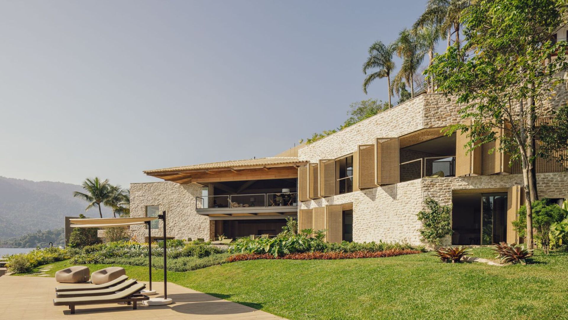 Outside view of Angra House, characterised by earthy textures and nature.