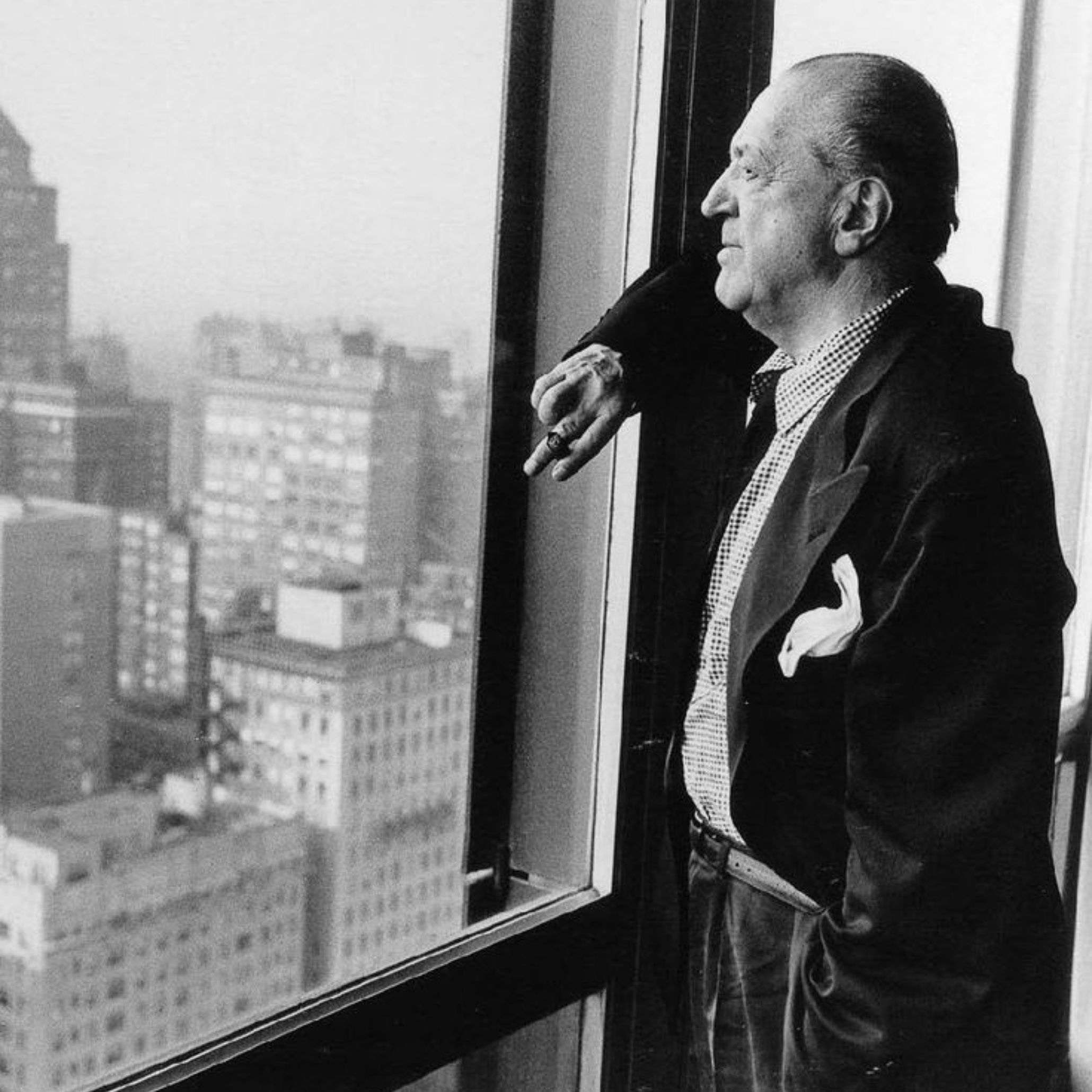 Mies van der Rohe looking at the view from inside the Seagram Building.