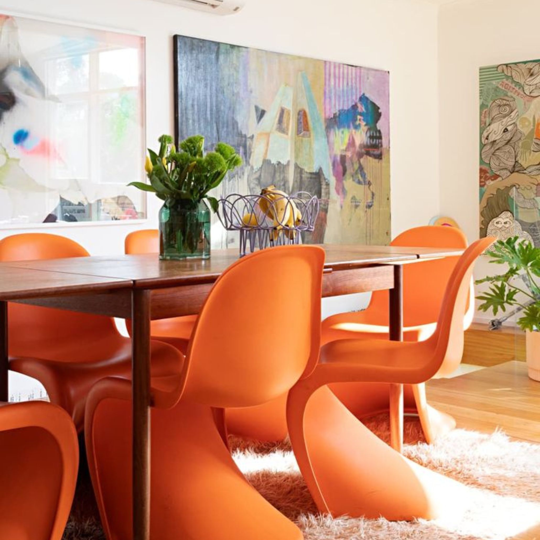 Colorful dining room with Panton chairs.