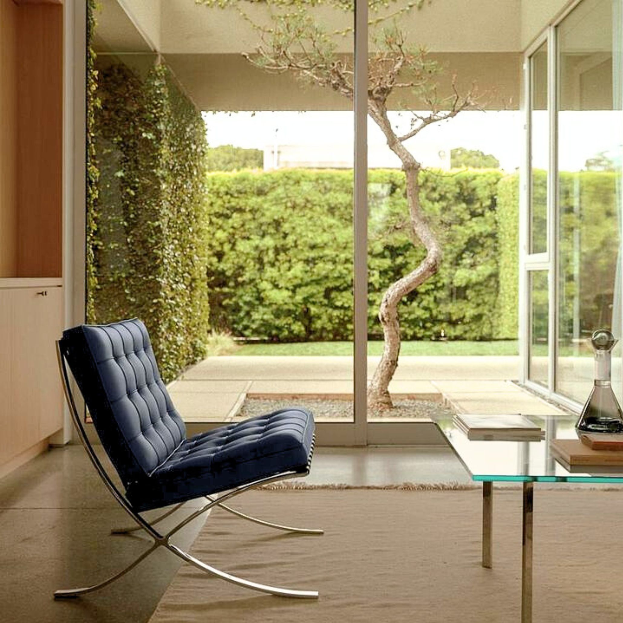 Garden-view living room with Barcelona chairs