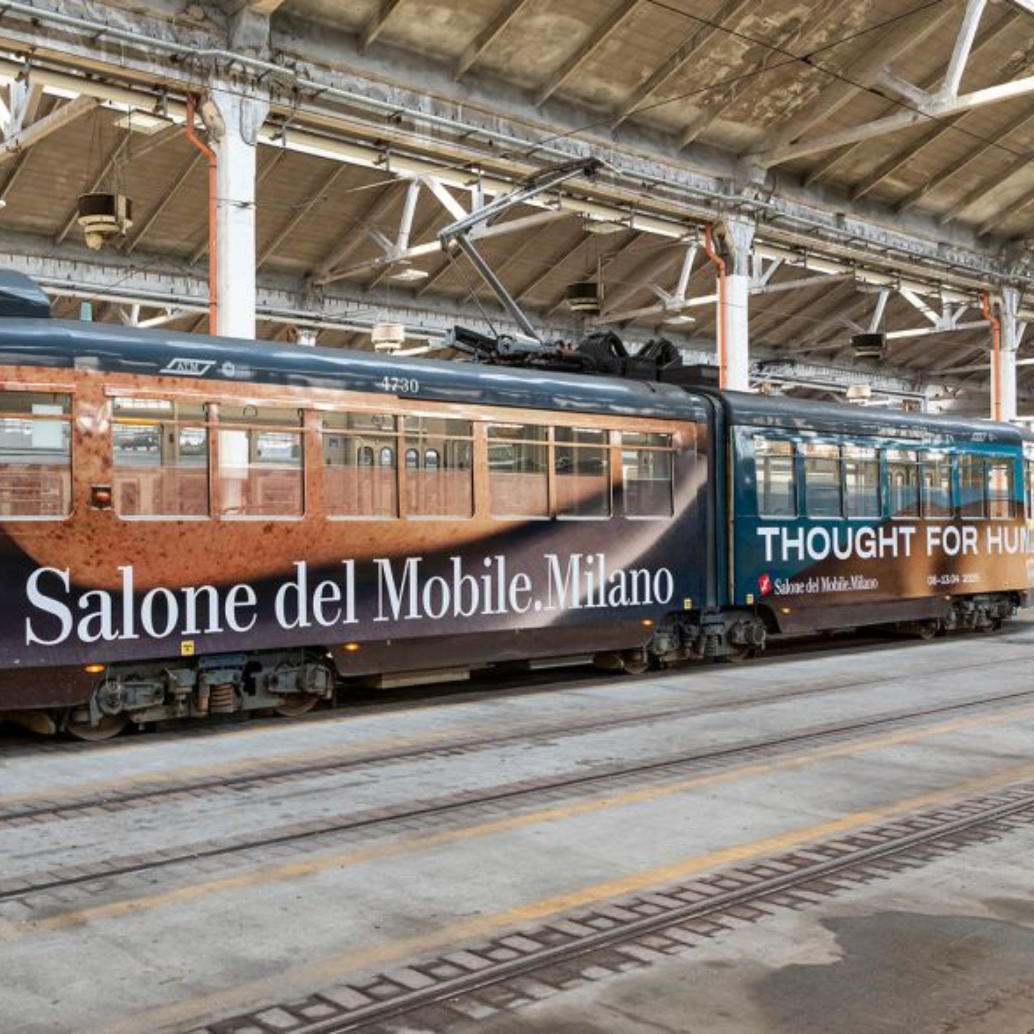 Public transportation in Milan wrapped in Thought for Humans theme graphics for Salone del Mobile 2025.