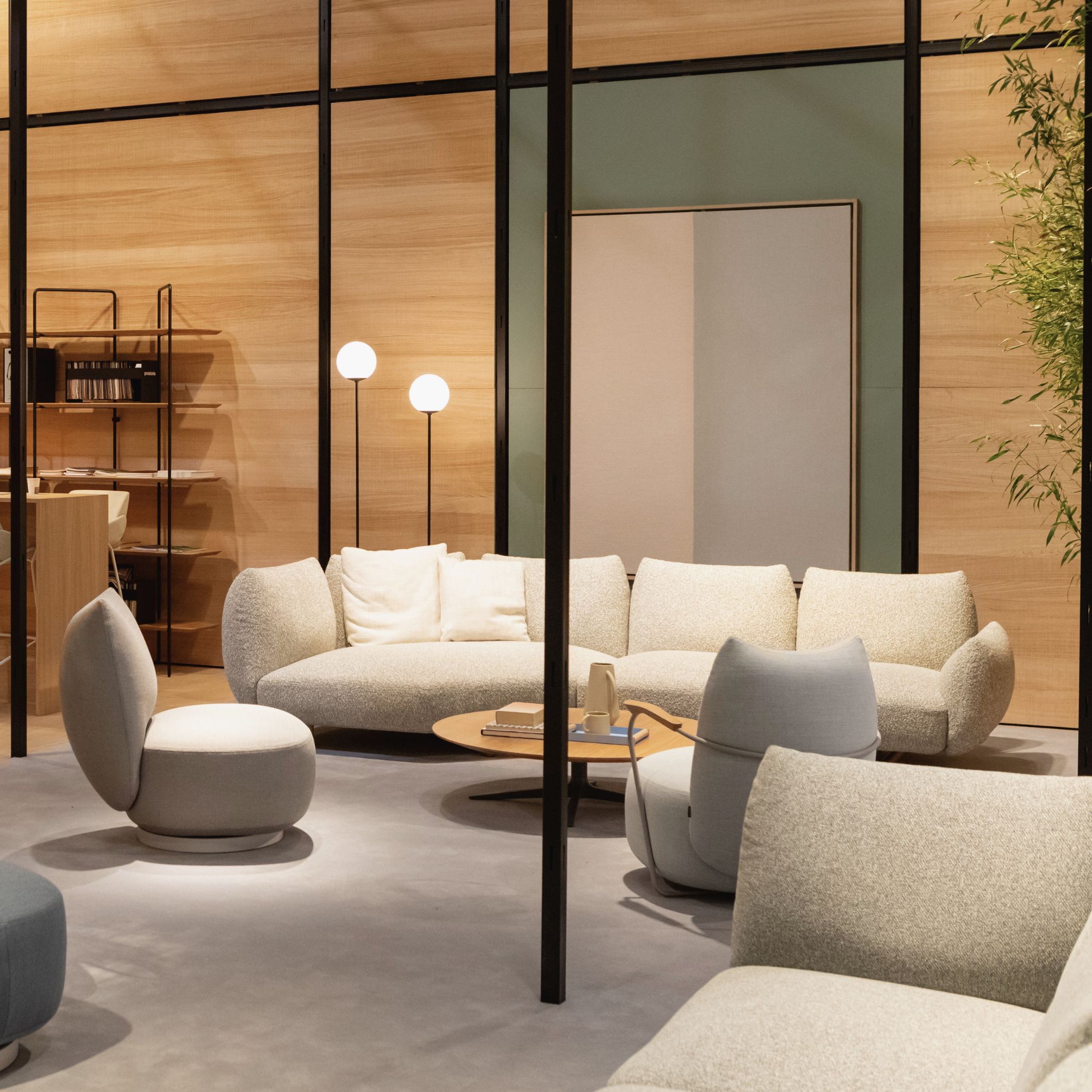 A sculptural sofa with flowing, organic curves and subtle angular accents, embodying the 2025 trend of fluid forms showcased at Salone del Mobile.