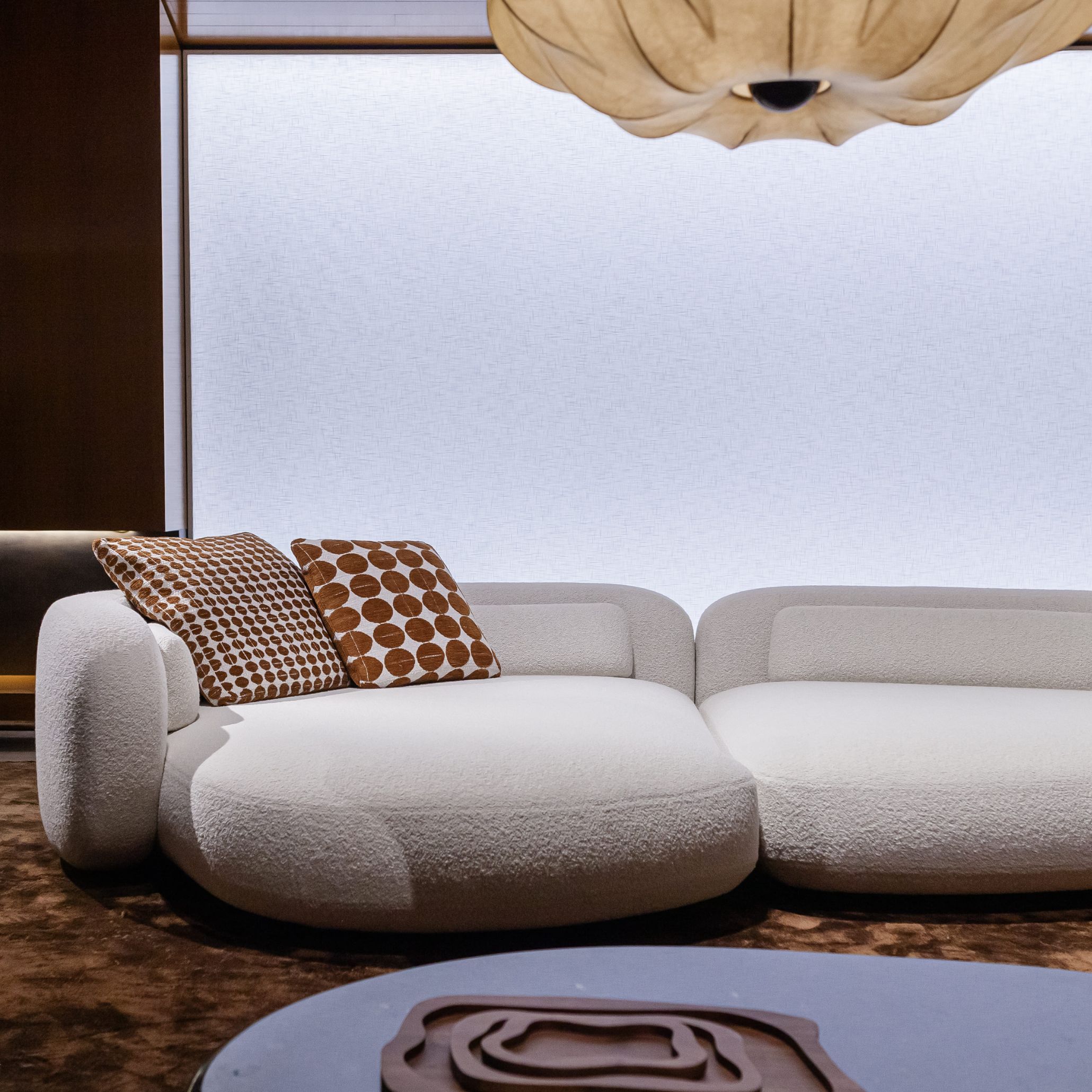 A cozy sofa upholstered in soft bouclé fabric, reflecting the 2025 trend of tactile textures that bring warmth and depth to interiors.