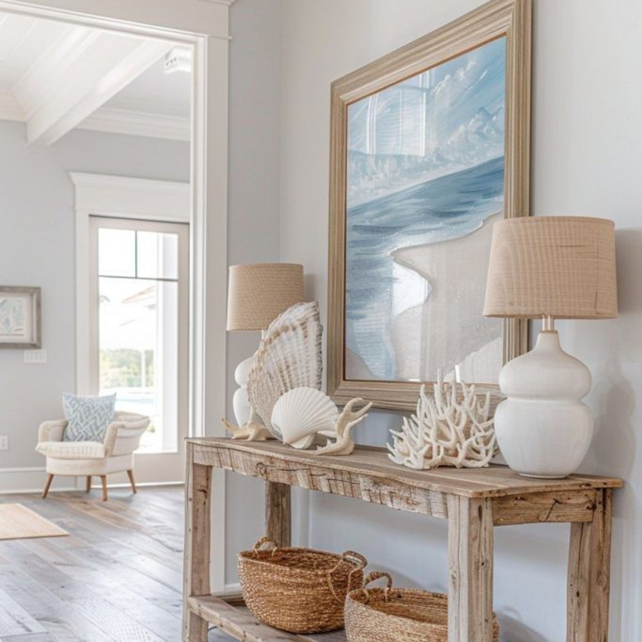 Entryway styled with natural elements and coastal decor, including seashells, corals and driftwood-inspired textures, capturing the authenticity of Contemporary Coastal Interior Design.