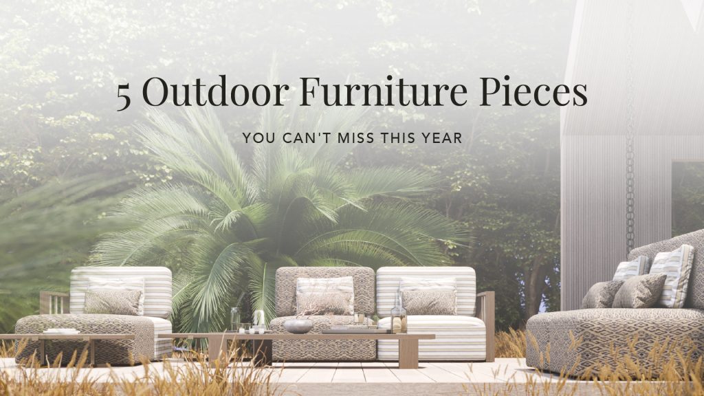 Promotional banner titled "5 Outdoor Furniture Pieces You Can’t Miss This Year," featuring a serene Hamptons-inspired outdoor setting. The image showcases the Bespoke Her Sofa by Stylish Club with modular striped and patterned cushions, paired with the Escarpa Coffee Table in Grey Oak Mate. Surrounded by lush greenery and architectural wood panels, the scene embodies elegant outdoor living.