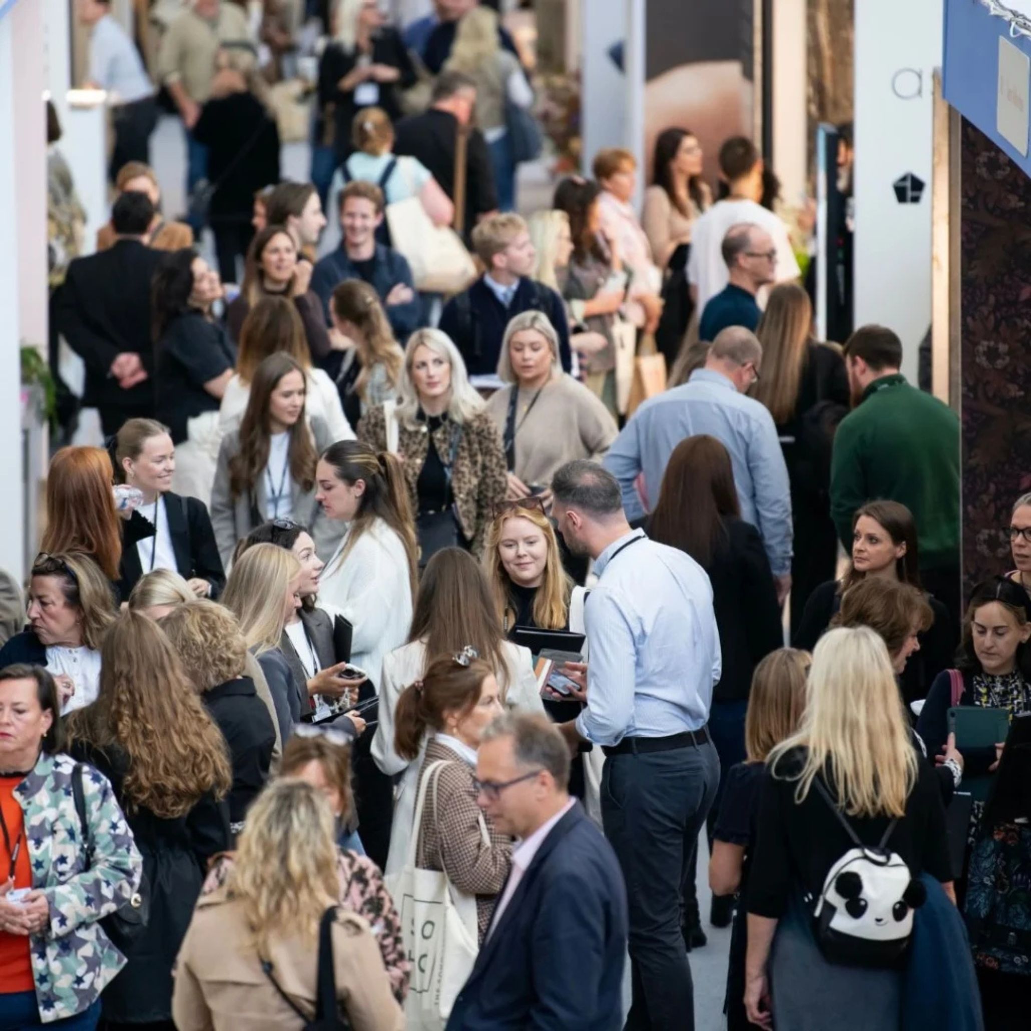 A crowd of visitors at Decorex 2025 engaging in conversations and exchanging interior design ideas.