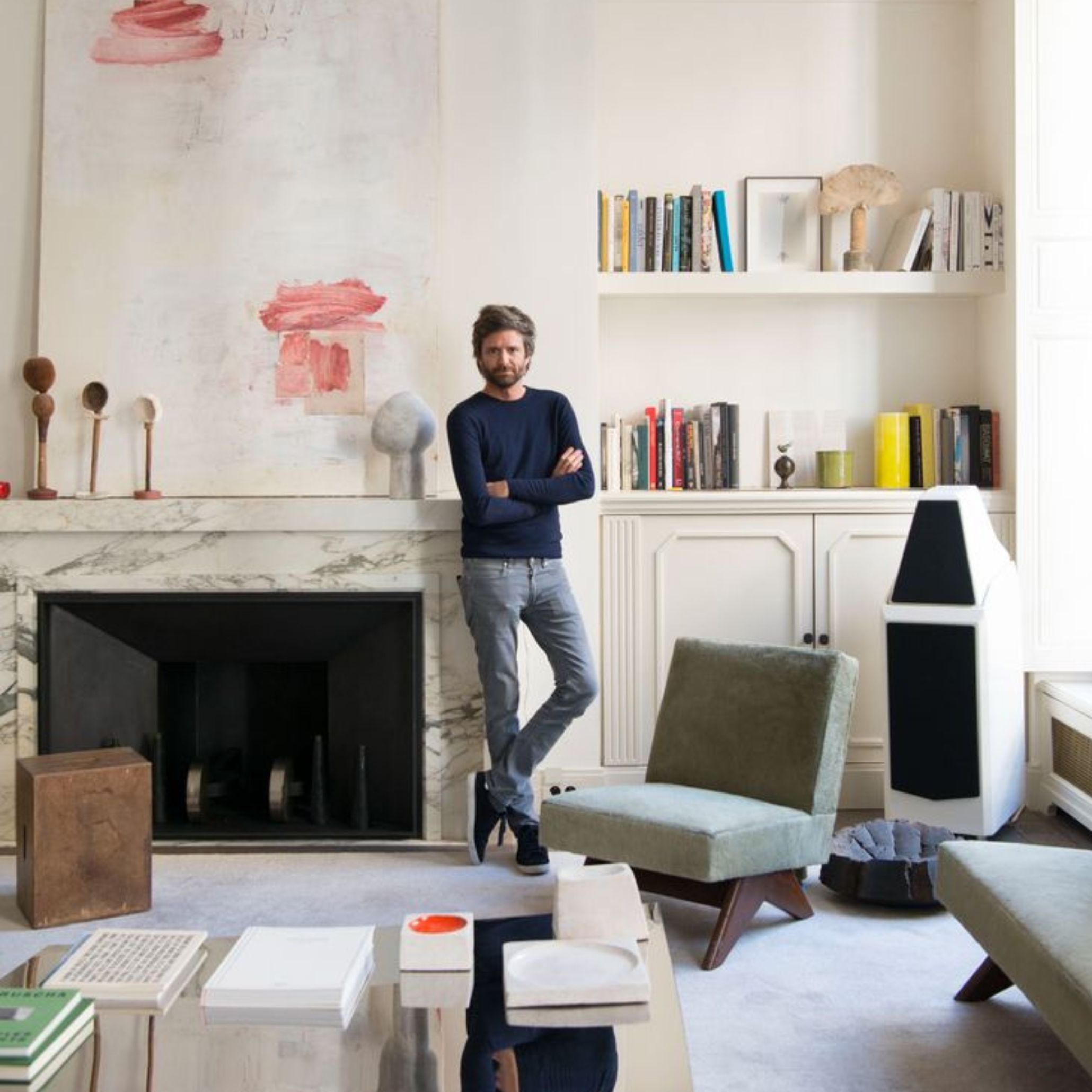 Joseph Dirand standing inside the Alboni residence, surrounded by sculptural furniture and refined minimalism that reflect his precise, experiential approach to space and form.