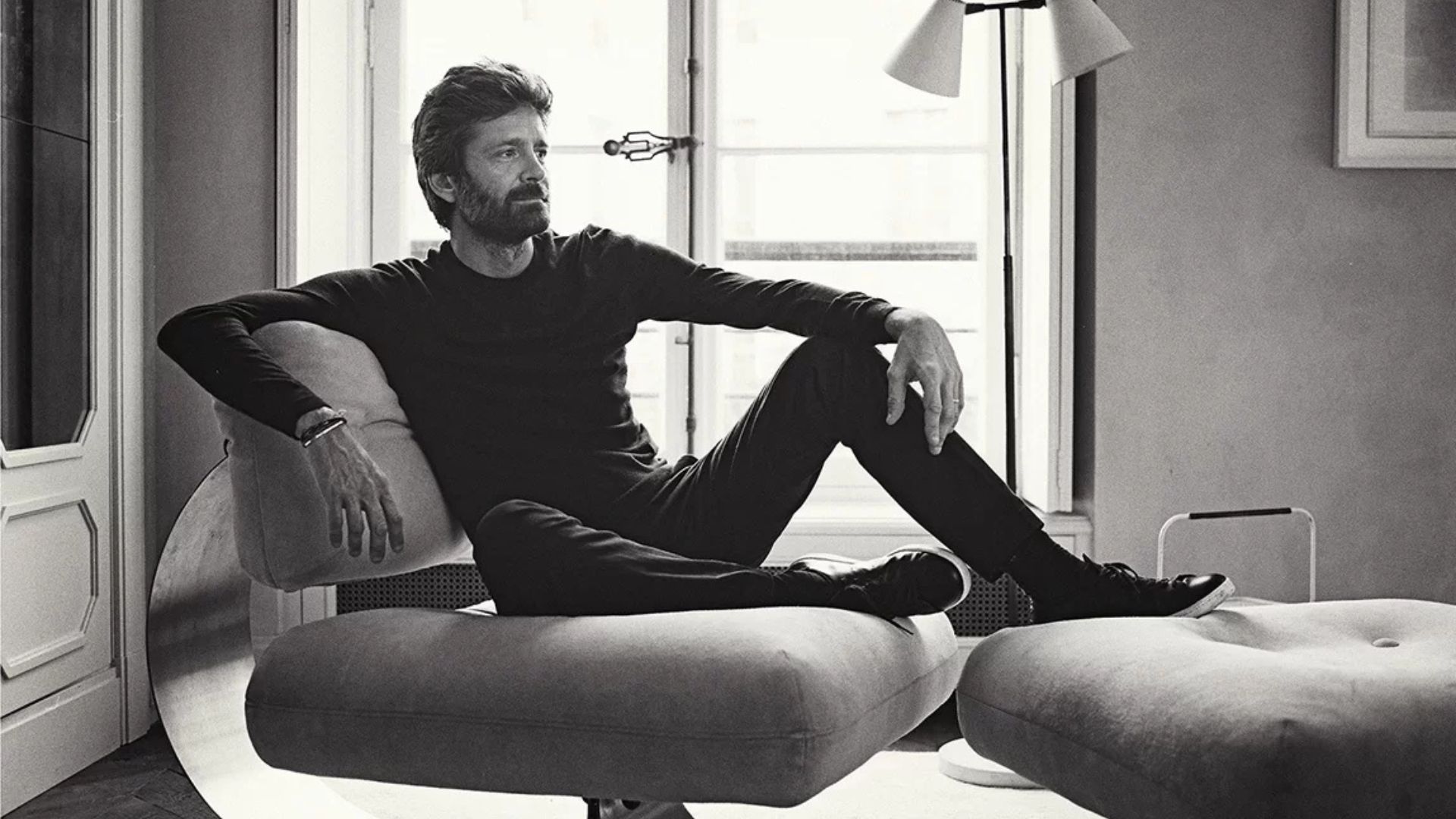 Black-and-white portrait of Joseph Dirand in a minimalist interior, embodying his disciplined approach to space, proportion, and quiet elegance.