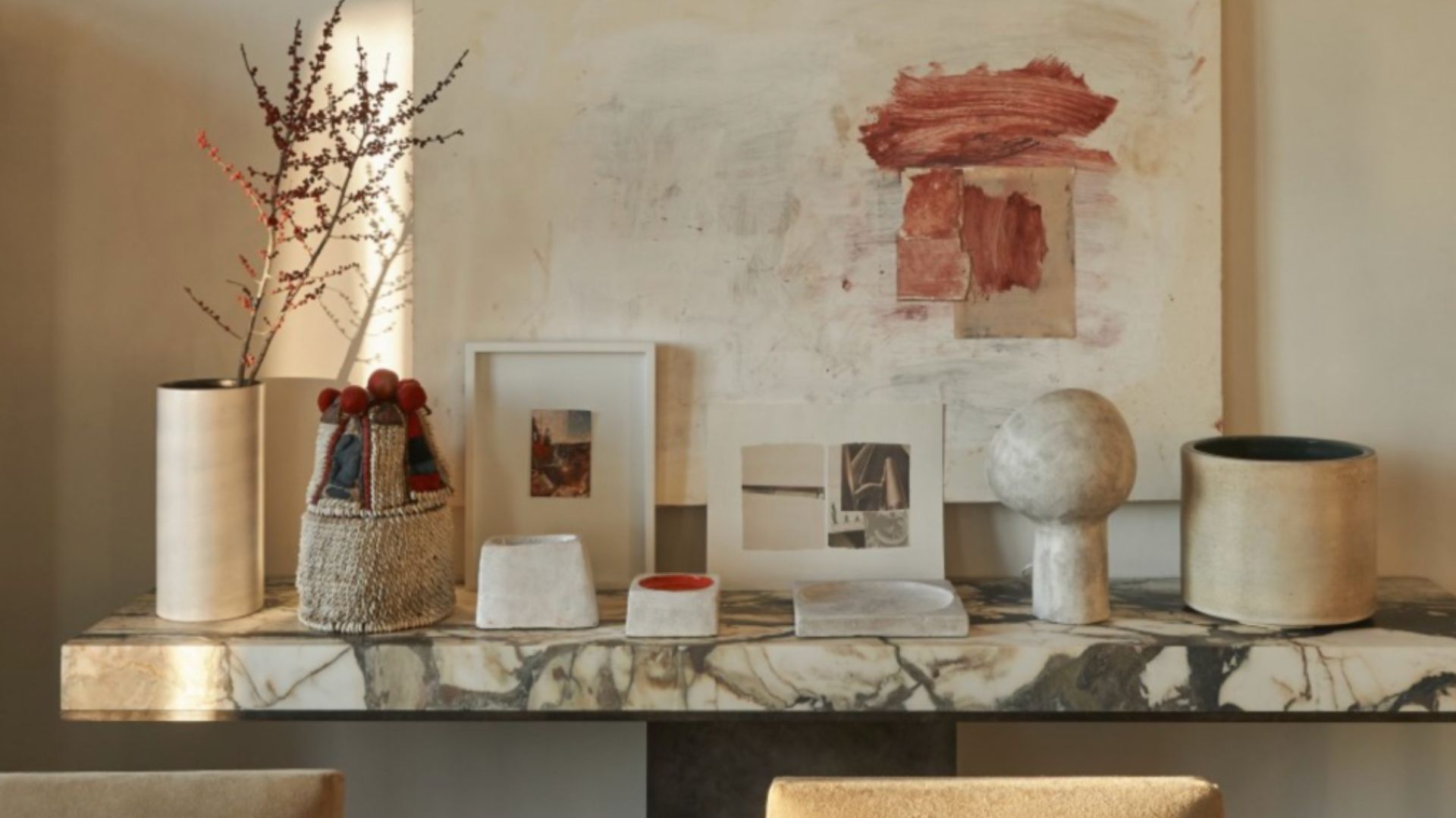 A marble console styled with sculptural vessels, framed art, and natural element - an expression of Joseph Dirand’s material discipline. The restrained palette and tactile finishes highlight his architectural approach, where texture, weight, and repetition create spatial clarity and lasting presence.