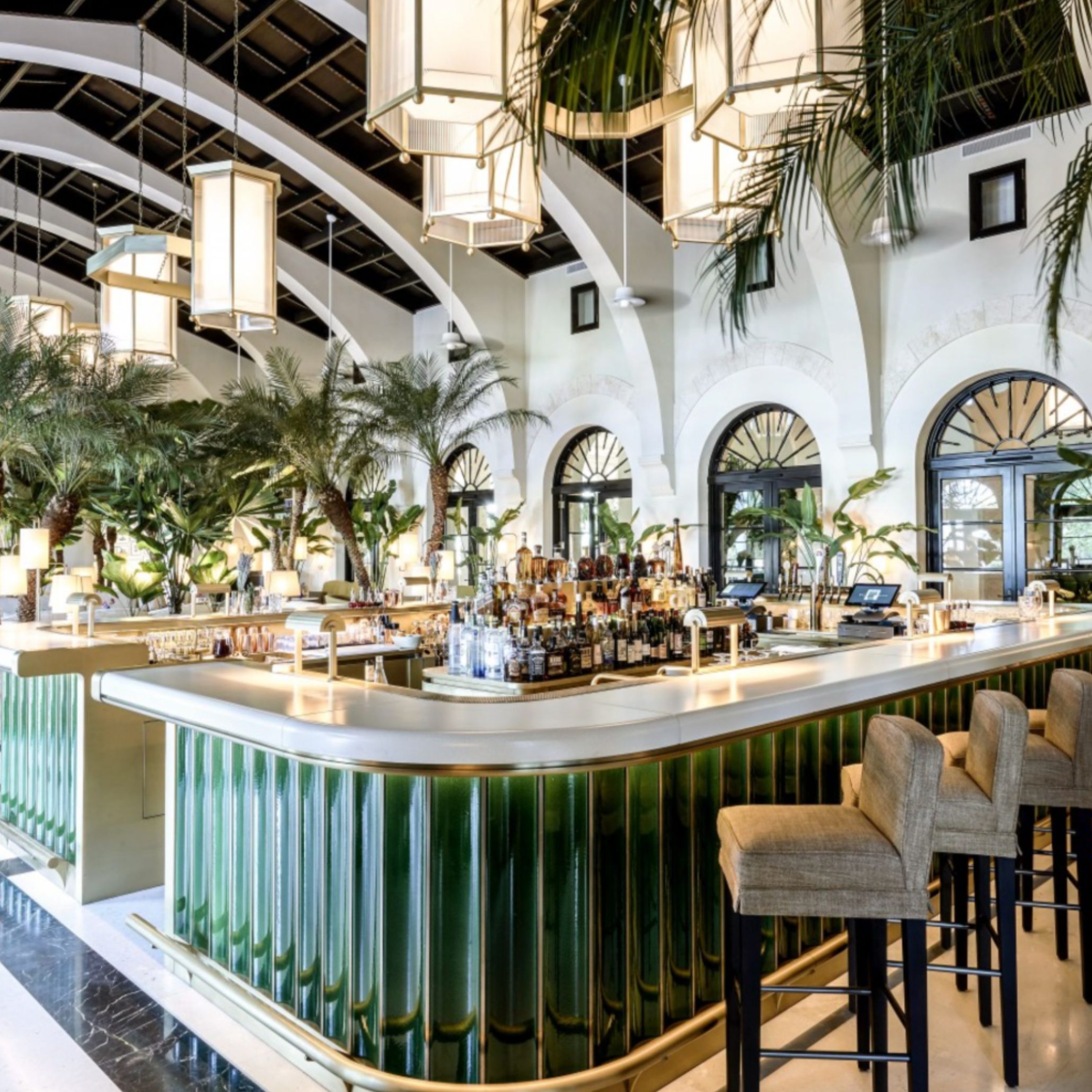 A view of the bar at The Surf Club, featuring sculptural seating, warm stone surfaces, and soft coastal light. Joseph Dirand’s design balances openness with structure, using proportion and material clarity to create a serene, enduring atmosphere connected to the shoreline.