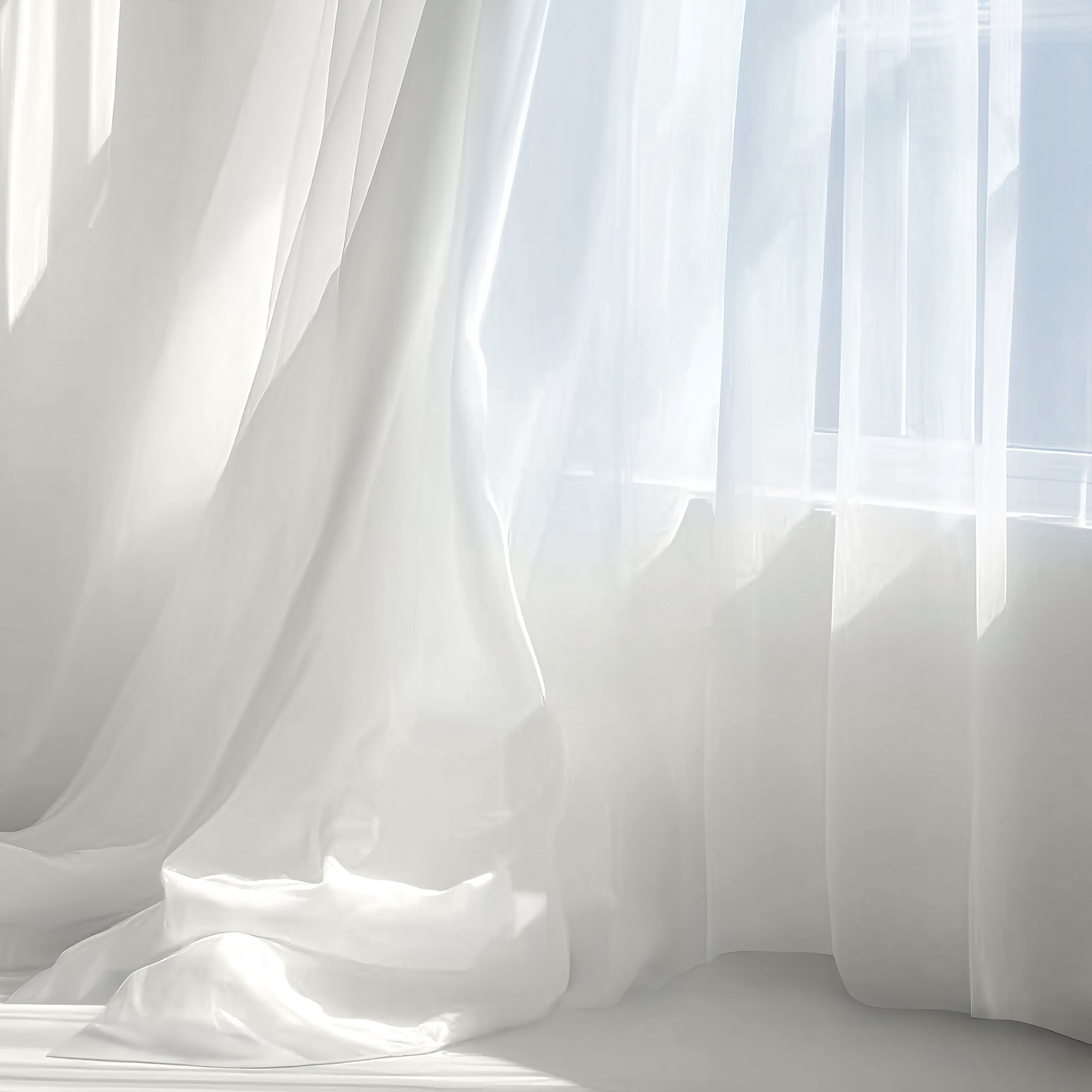 Sheer white curtains gently filter sunlight, casting delicate shadows across the room. The translucent fabric moves softly with the air, enhancing the interplay of light and texture. A moment of stillness that represent Cloud Dancer’s calm and luminous essence.