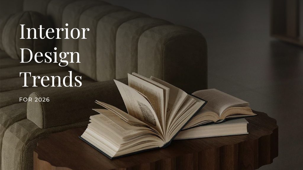 Stylish interior with a textured green sofa and scalloped-edge wooden coffee table displaying open books, evoking a cozy, intellectual ambiance. Overlay text reads 'Interior Design Trends for 2026,' suggesting a focus on upcoming home decor inspirations.