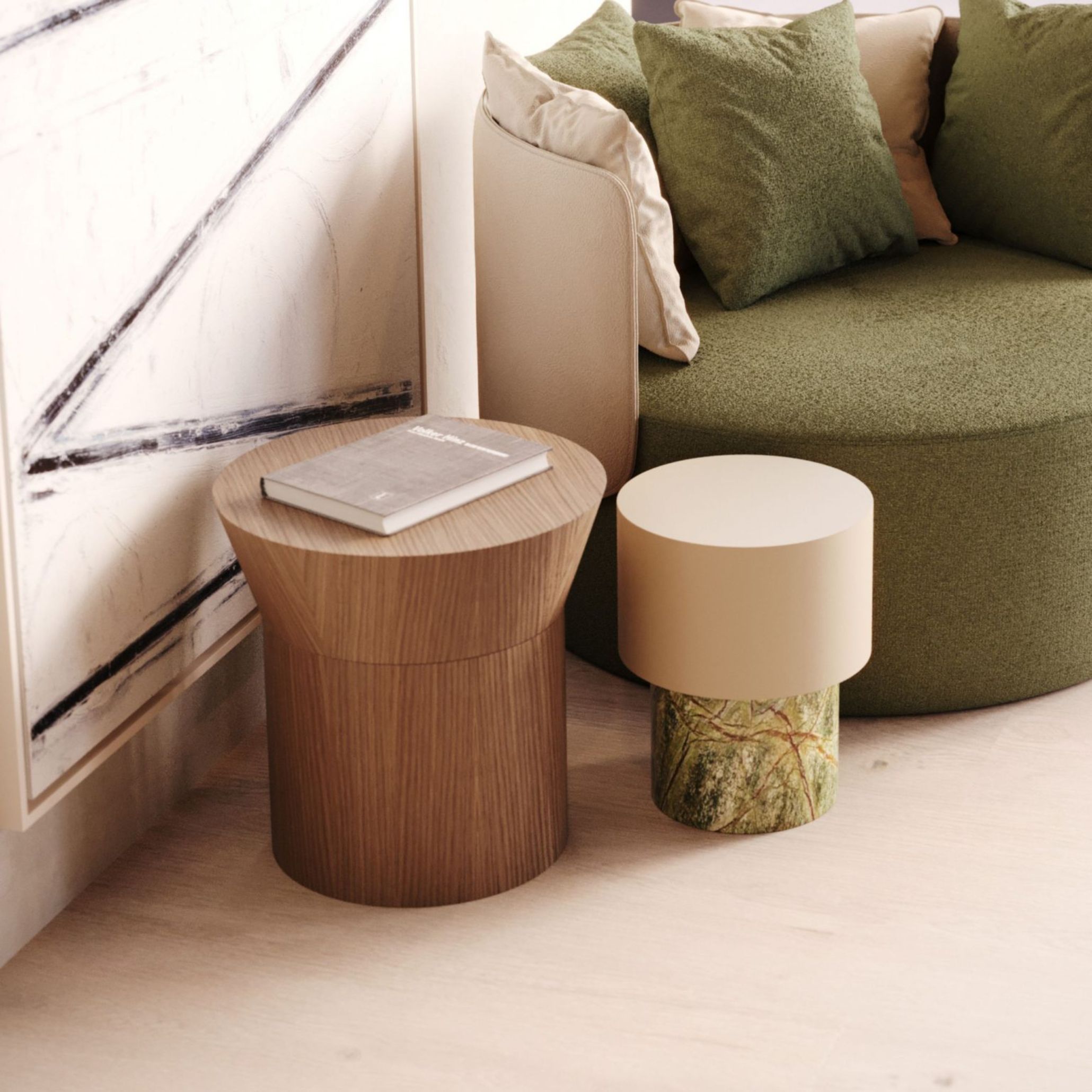 A modern corner featuring a round green upholstered Margemchair layered with green and beige cushions, paired with the Toro Side Table, whose sculptural wooden form adds warmth and craftsmanship. A second marbled side table and a bold abstract artwork complete the scene, showcasing how refined accents and thoughtful details bring depth and personality to a curated interior.