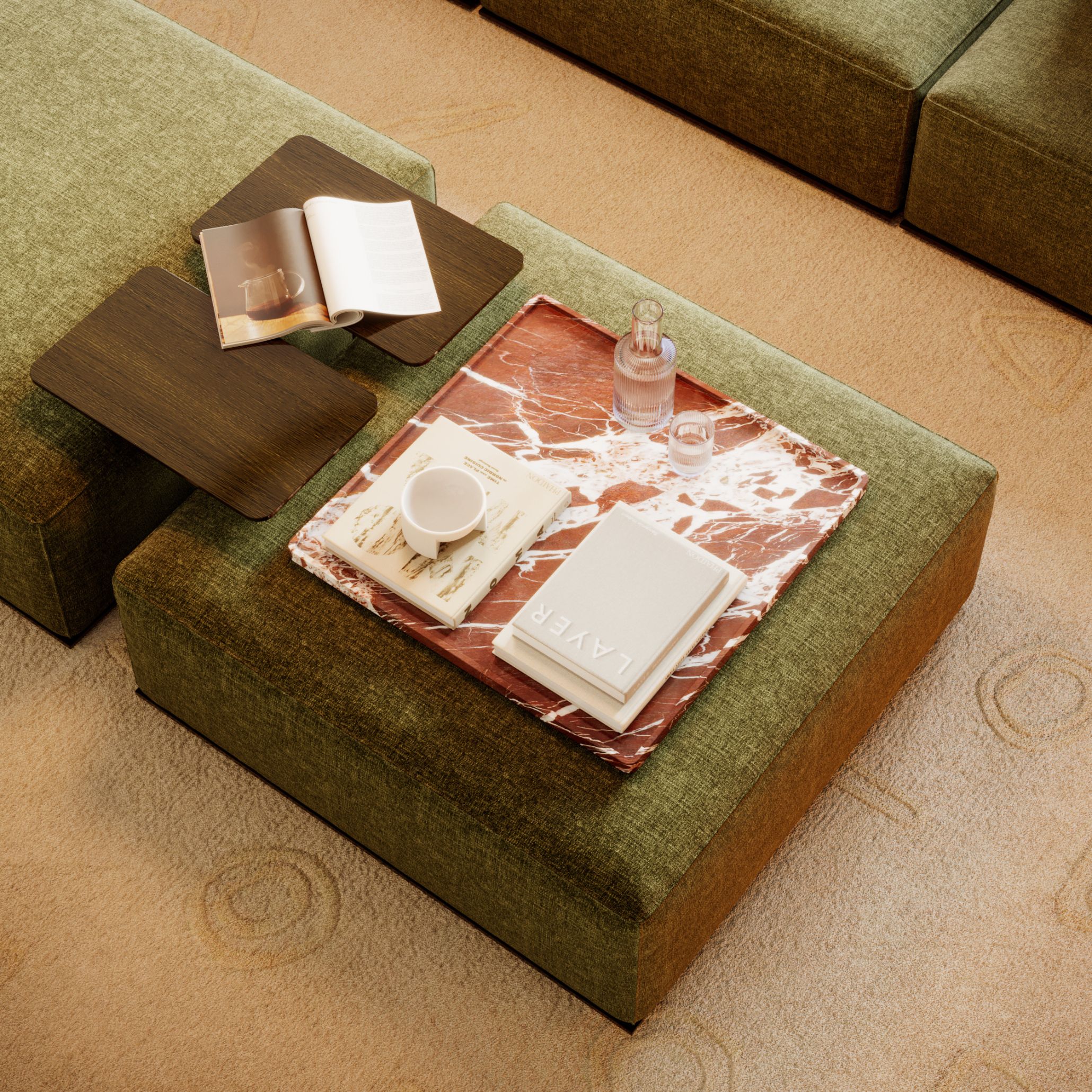 Green Landform Modular Sofa styled with a Rosso Levanto marble board holding books and glassware. Its rich veining and sculptural presence introduce depth and quiet drama, reflecting 2026’s embrace of tactile materials that elevate everyday interiors.
