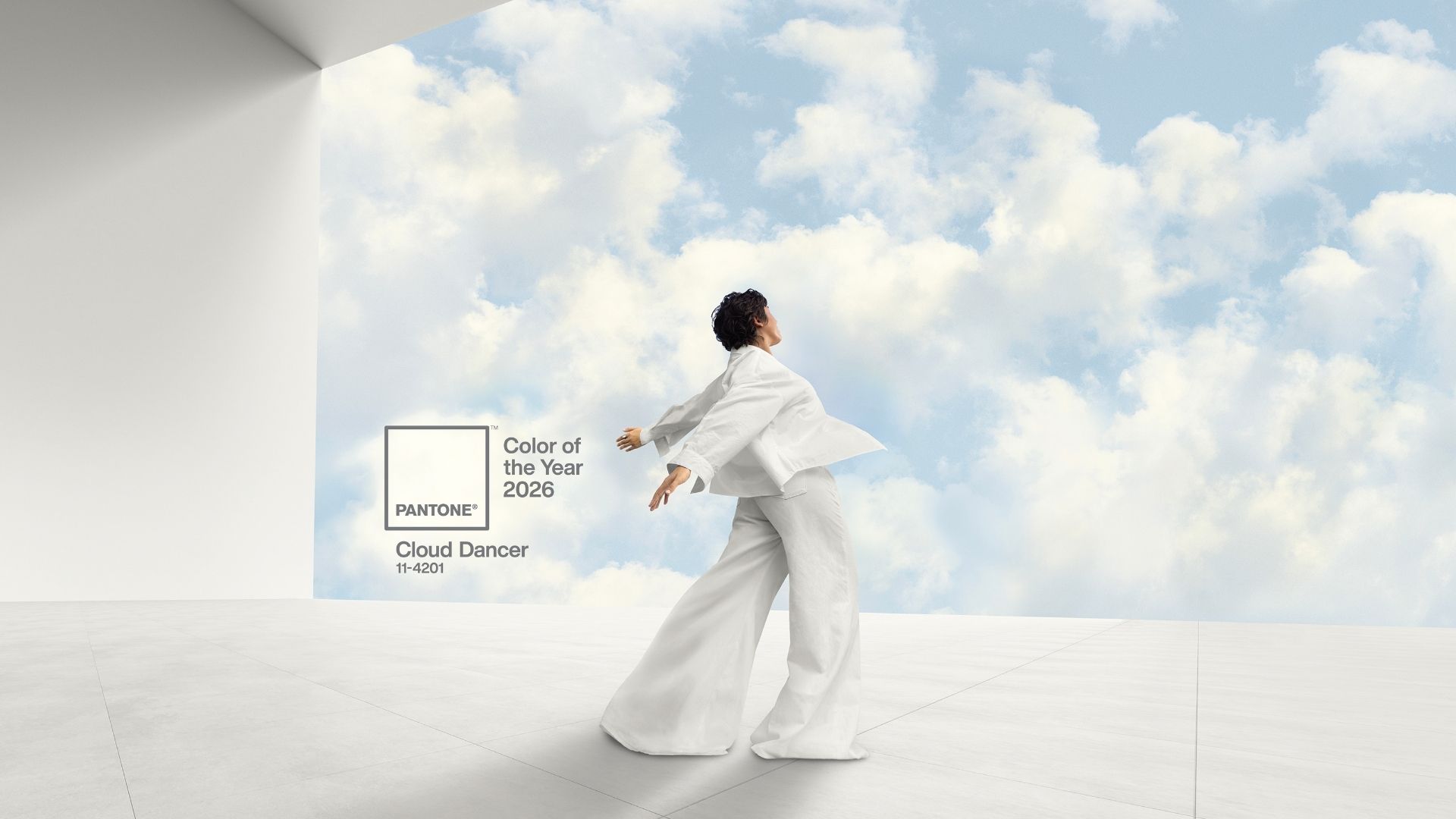 Set against a luminous cloudscape, a person in white moves gracefully across a light-toned surface, capturing the essence of Pantone’s Cloud Dancer. The image conveys a feeling of weightlessness and introspection, with the soft textures and airy palette symbolizing balance, focus, and the beauty of restraint. It’s a visual meditation on the power of minimalism and the emotional depth of quiet design.