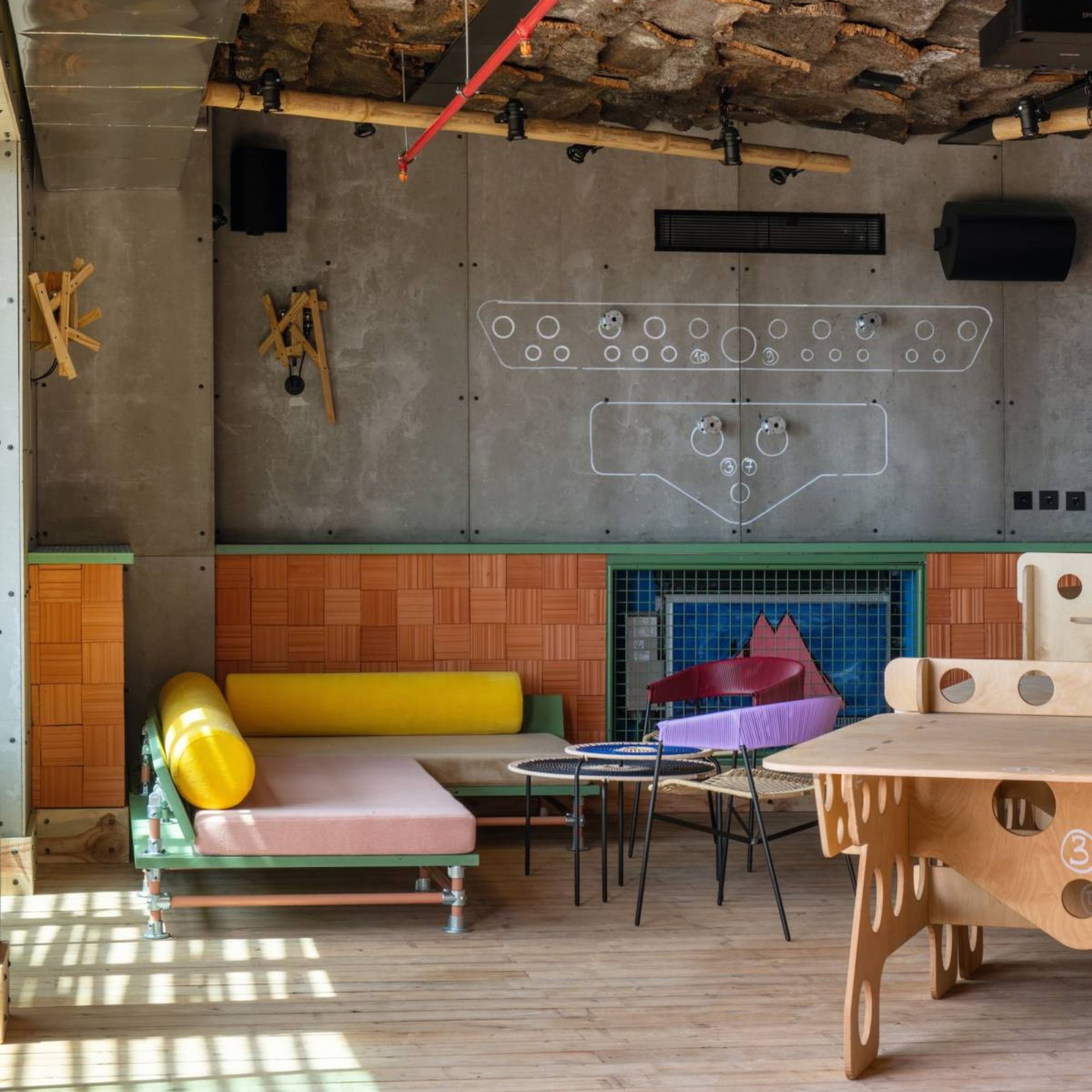 Interior scene illustrating the Metamorphosis trend, combining raw industrial elements with playful, reworked materials. Concrete surfaces, bark textures, exposed pipes, and pastel modular seating come together in an unexpected composition that reflects transformation through upcycling and creative reinvention.