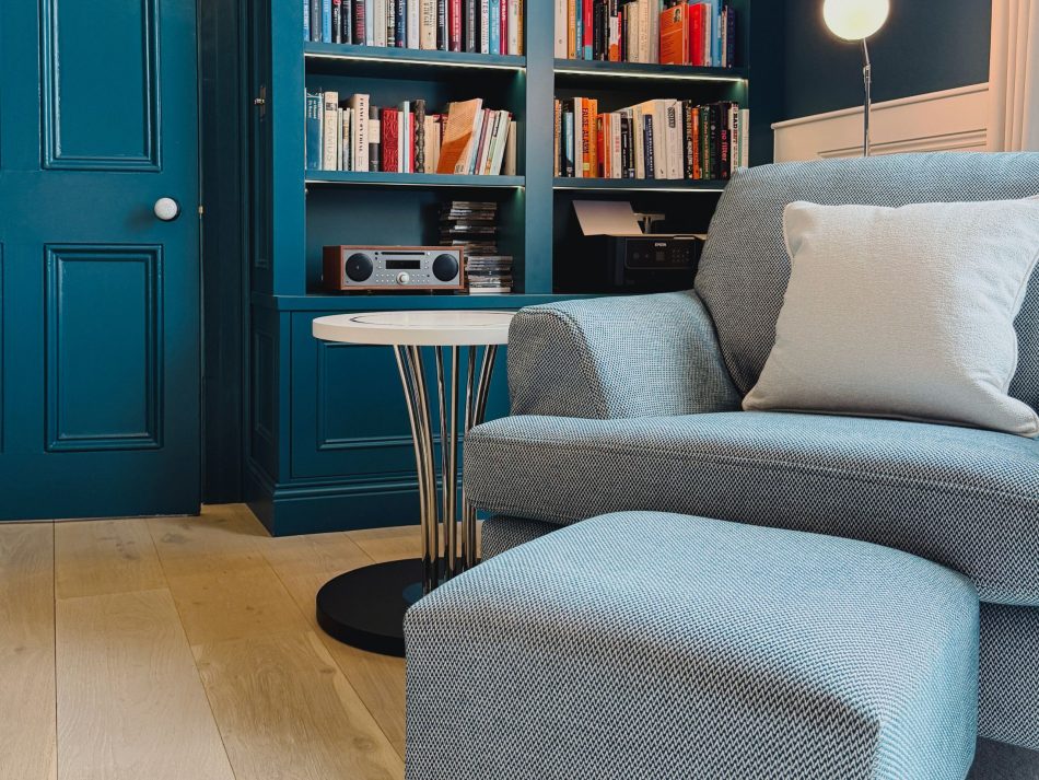 Inviting reading nook at Rathgar Villa with the Sublime Side Table, a plush armchair, and built-in bookshelves - where calm, comfort, and inspiration meet in a composed setting.