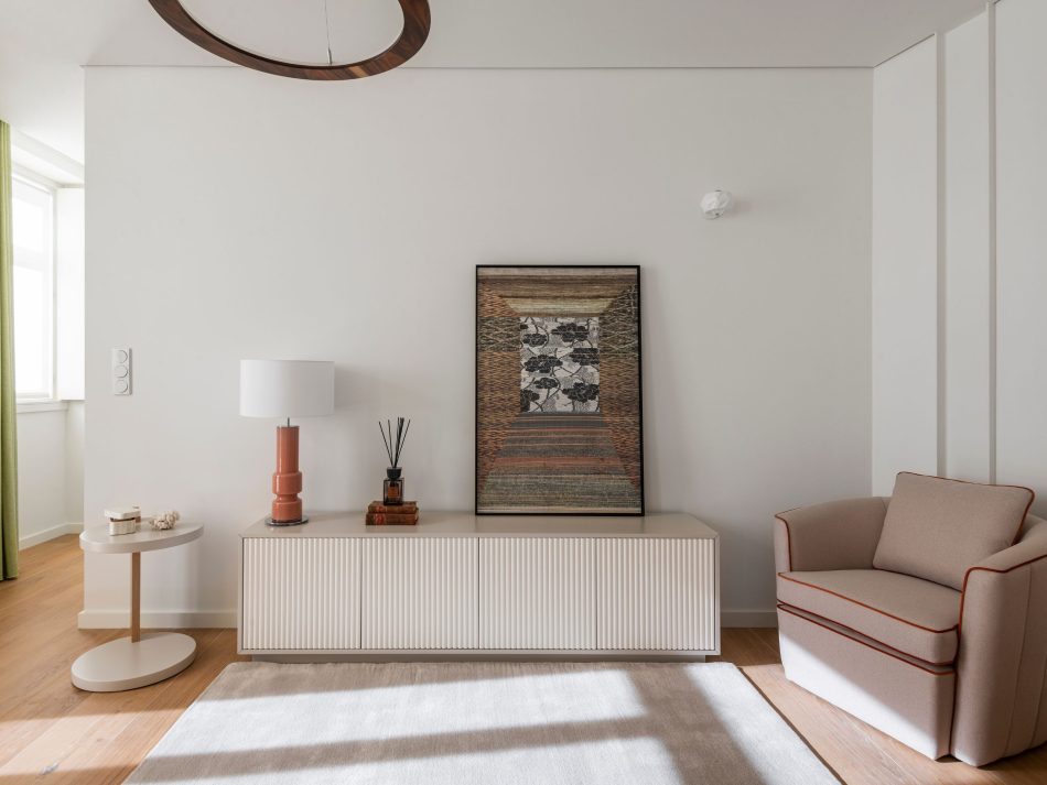 A serene living room where the Fortune Armchair anchors the space with its soft curves and inviting presence, paired with the Club Side Table that adds subtle functionality. The bespoke Ryan TV Cabinet stretches along the wall with its refined craftsmanship, grounding the room in warm tones and gentle textures. Natural light enhances the calm composition, expressing luxury living room furniture and the quiet balance of modern furniture.