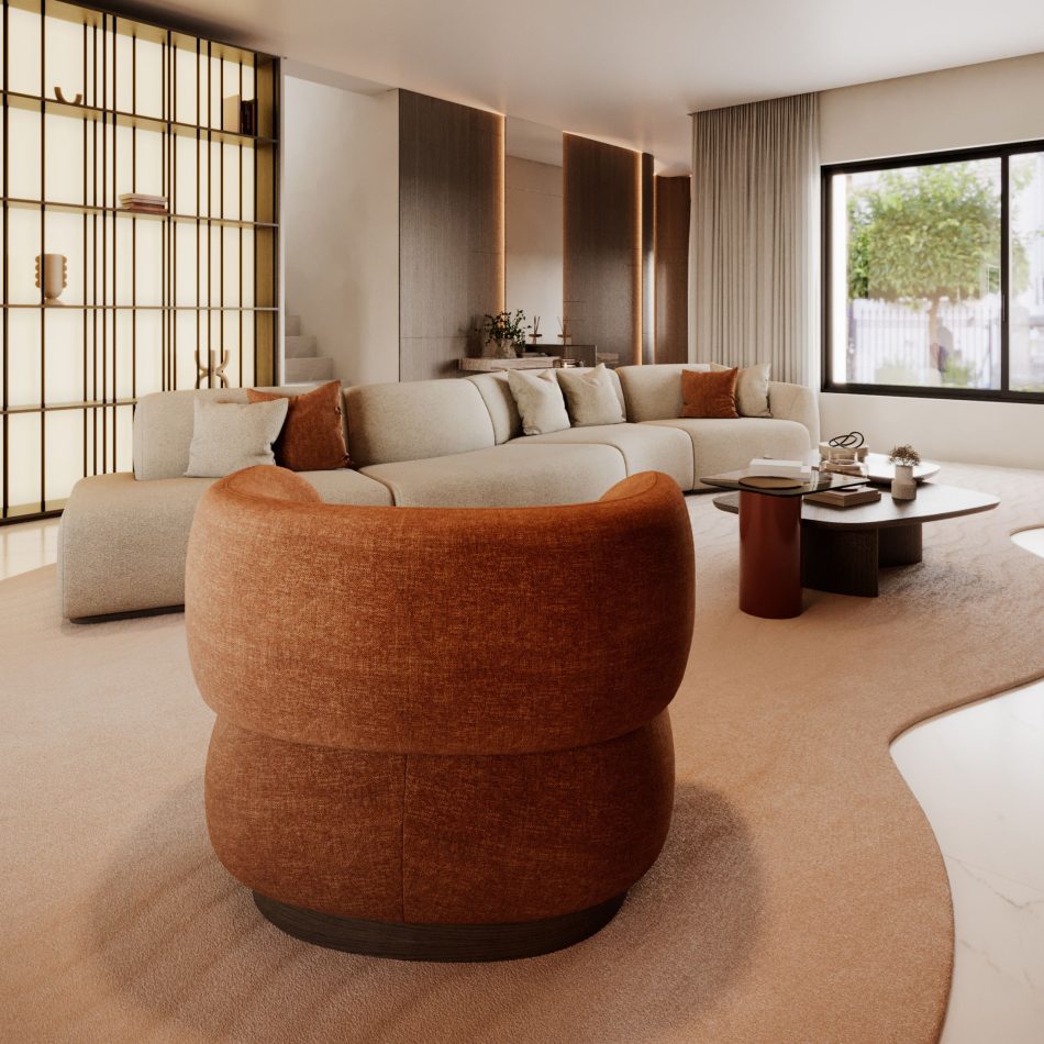 A sophisticated living room in warm beige and earthy brown tones featuring the rust‑colored Dolomites Armchair, whose rounded, mountain‑inspired curves contrast beautifully with the soft sectional sofa, dark wood coffee table, and softly illuminated wall panels, creating a serene and grounded atmosphere that aligns with luxury living room furniture, the crafted harmony of home furniture, and the sculptural calm found in living room architecture.