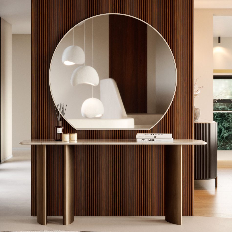 A softly illuminated entrance hall featuring the Dolomites Console with its marble surface and cylindrical wooden legs, positioned beneath a large circular mirror that reflects pendant lighting and soft upholstery, creating an atmosphere of elegance that resonates with luxury furniture, the crafted purity of modern furniture, and the serene flow of contemporary furniture design.
