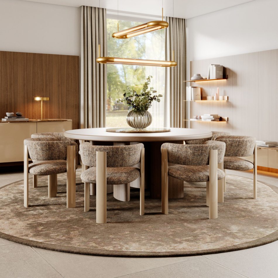 A serene dining area anchored by the Dolomites Round Dining Table, styled with a circular rug, neutral-toned chairs, and a simple glass vase centerpiece. The warm gold pendants and built‑in wooden cabinetry add depth and softness to the room, creating a balanced, contemporary environment. This interior showcases the elegance of dining room design, enriched by elements of luxury home furniture and gentle cues of kitchen inspiration.