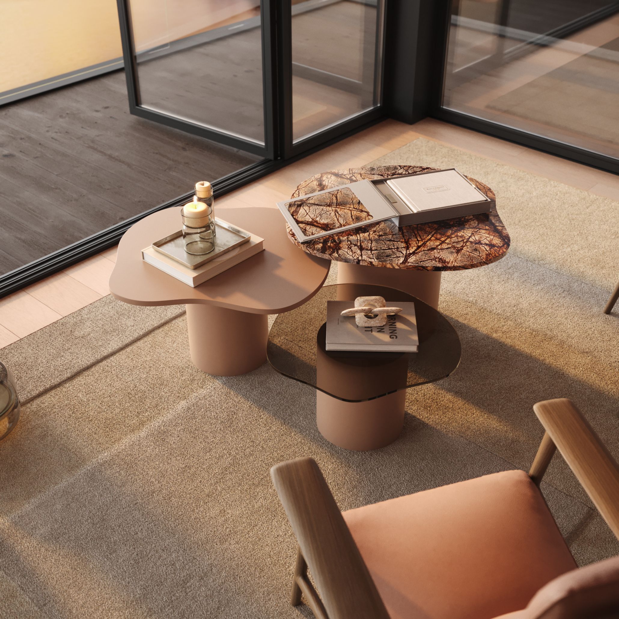 A bright contemporary living space showcasing three Natur Side Tables, each crafted in a different material, lacquer, glass and marble arranged together to form a fluid, nature‑inspired composition. Decorative candles, books, and sculptural accents enhance the refined atmosphere, highlighting the elegance of modern minimalist furniture and the organic movement that defines bespoke furniture design.