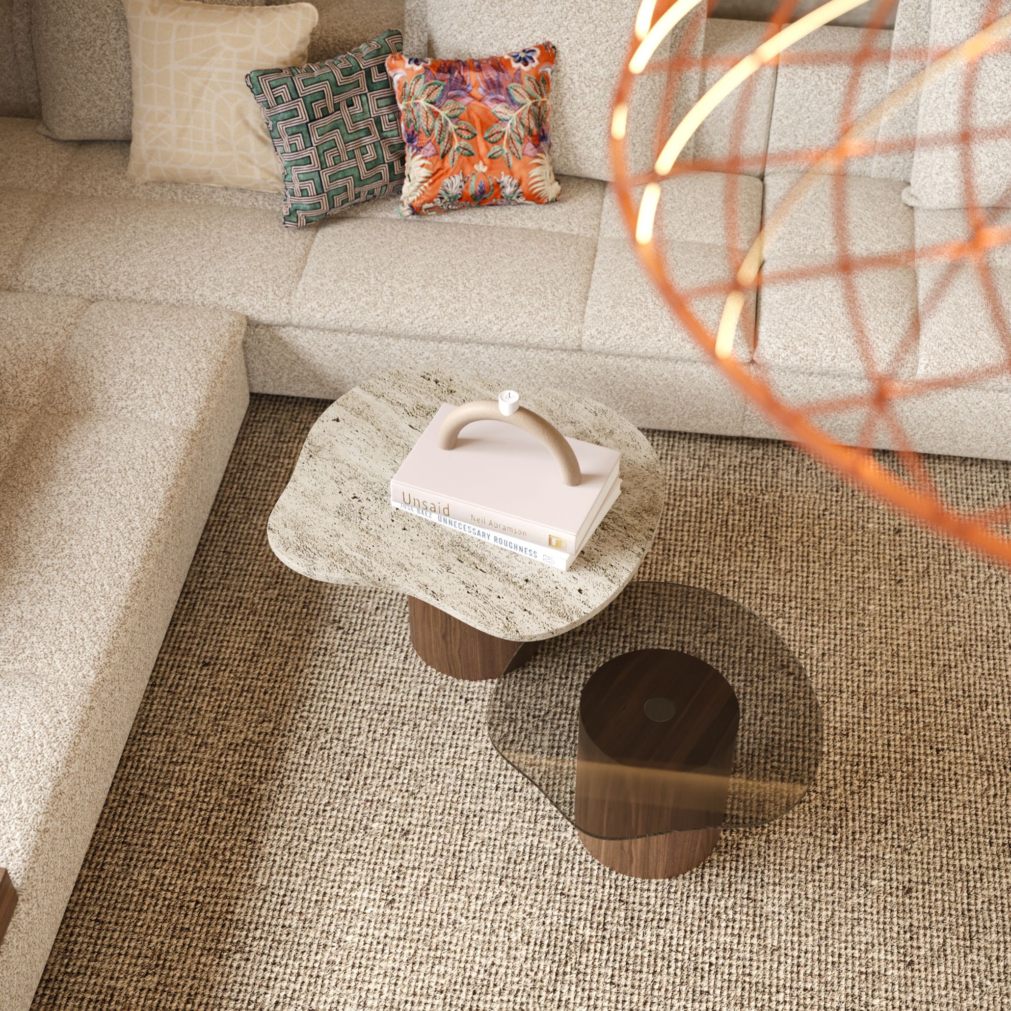 A cozy modern living room featuring a textured beige sectional sofa accented with patterned pillows, paired with a sculptural two Natur Side Table combining marble and tinted glass surfaces supported by wooden cylindrical bases. The mix of materials and soft organic shapes reflects bespoke furniture craftsmanship and the natural harmony central to luxury home furniture, creating a warm, inviting ambiance.