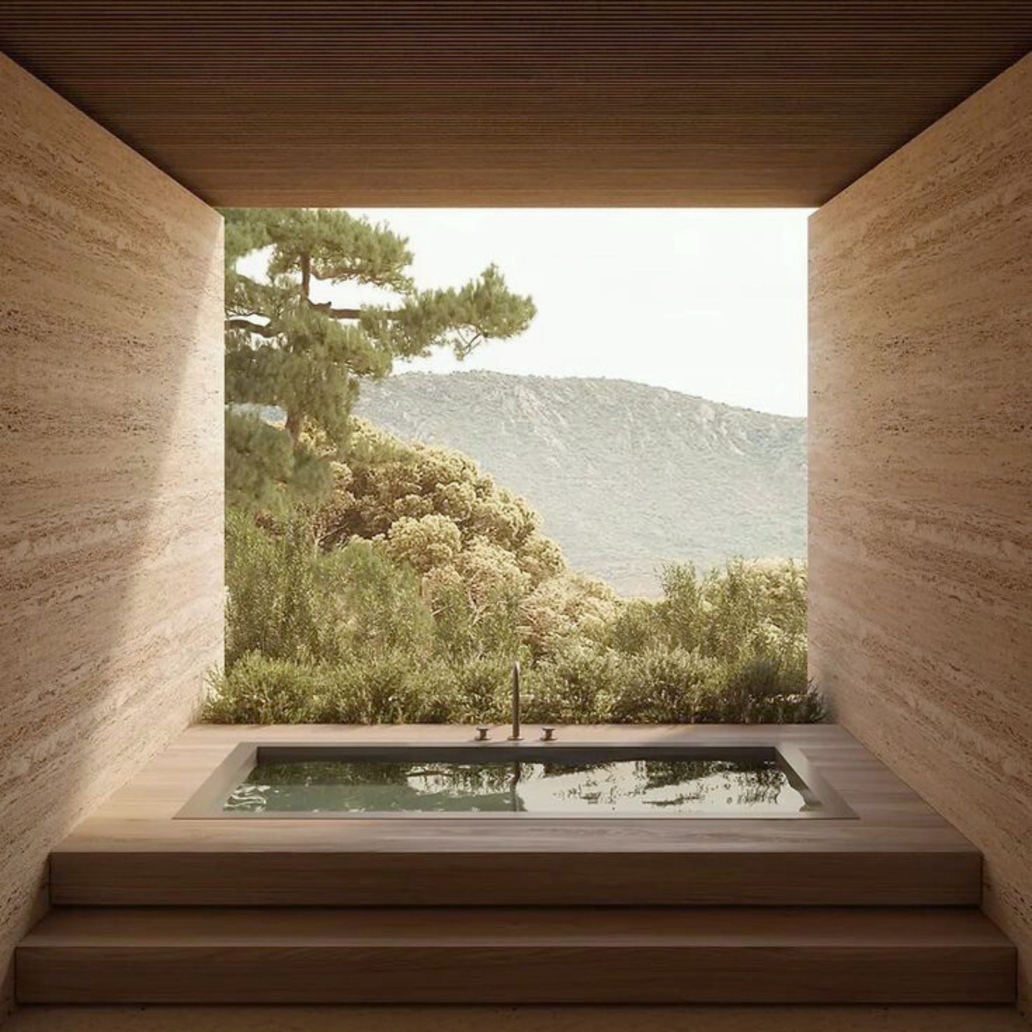 A tranquil bathing area featuring a recessed soaking tub framed by warm stone surfaces, opening to a lush natural landscape. The minimalist design and subtle home furniture elements evoke wellness architecture, where natural light, materials, and spatial clarity promote relaxation and harmony, enhanced by the presence of luxury home furniture and calming architectural lines.