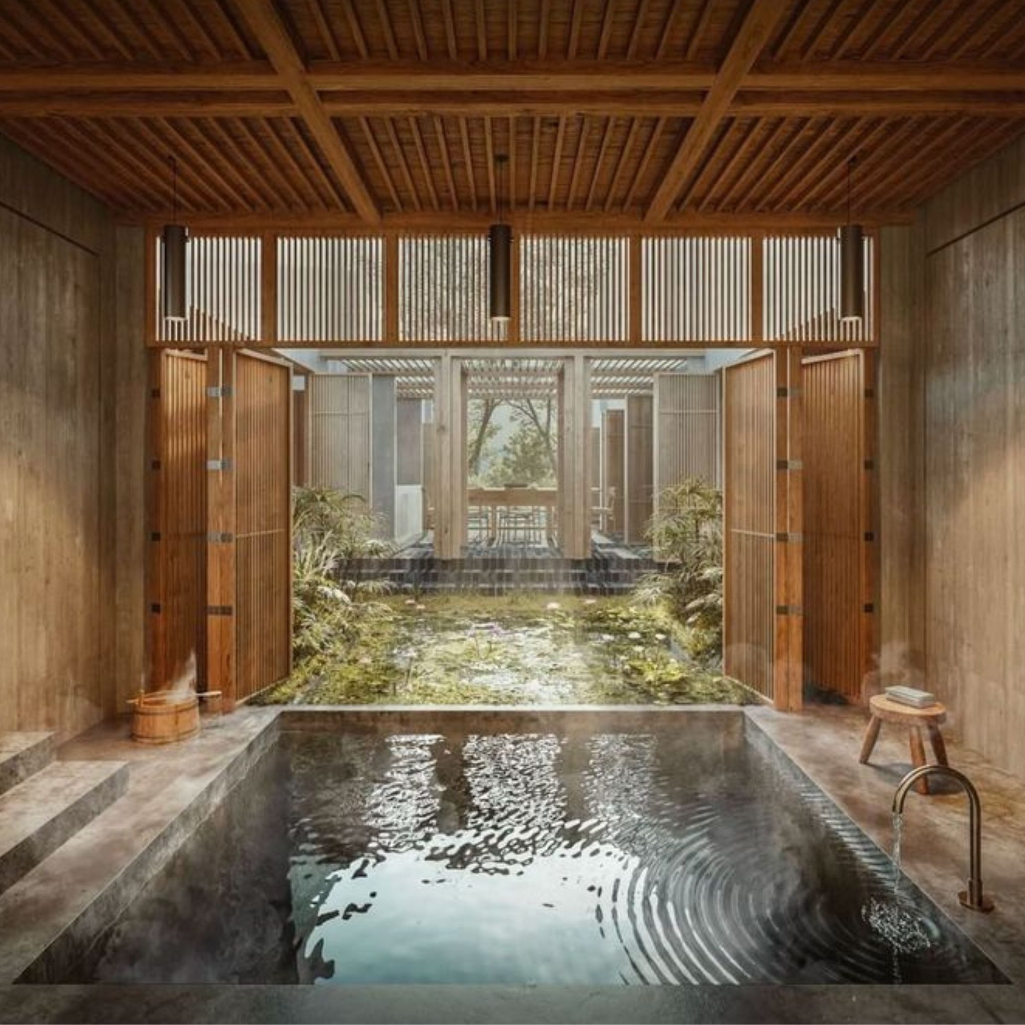 A serene Japanese onsen bath with steaming water flowing from a stone spout, framed by natural wood, stone steps, and an open view to a lush garden pond. Traditional bathing elements like a wooden stool and bucket complement the minimalist home furniture touches, expressing the cultural ritual of purification and the timeless connection between water, nature, and wellness supported by refined luxury home furniture.